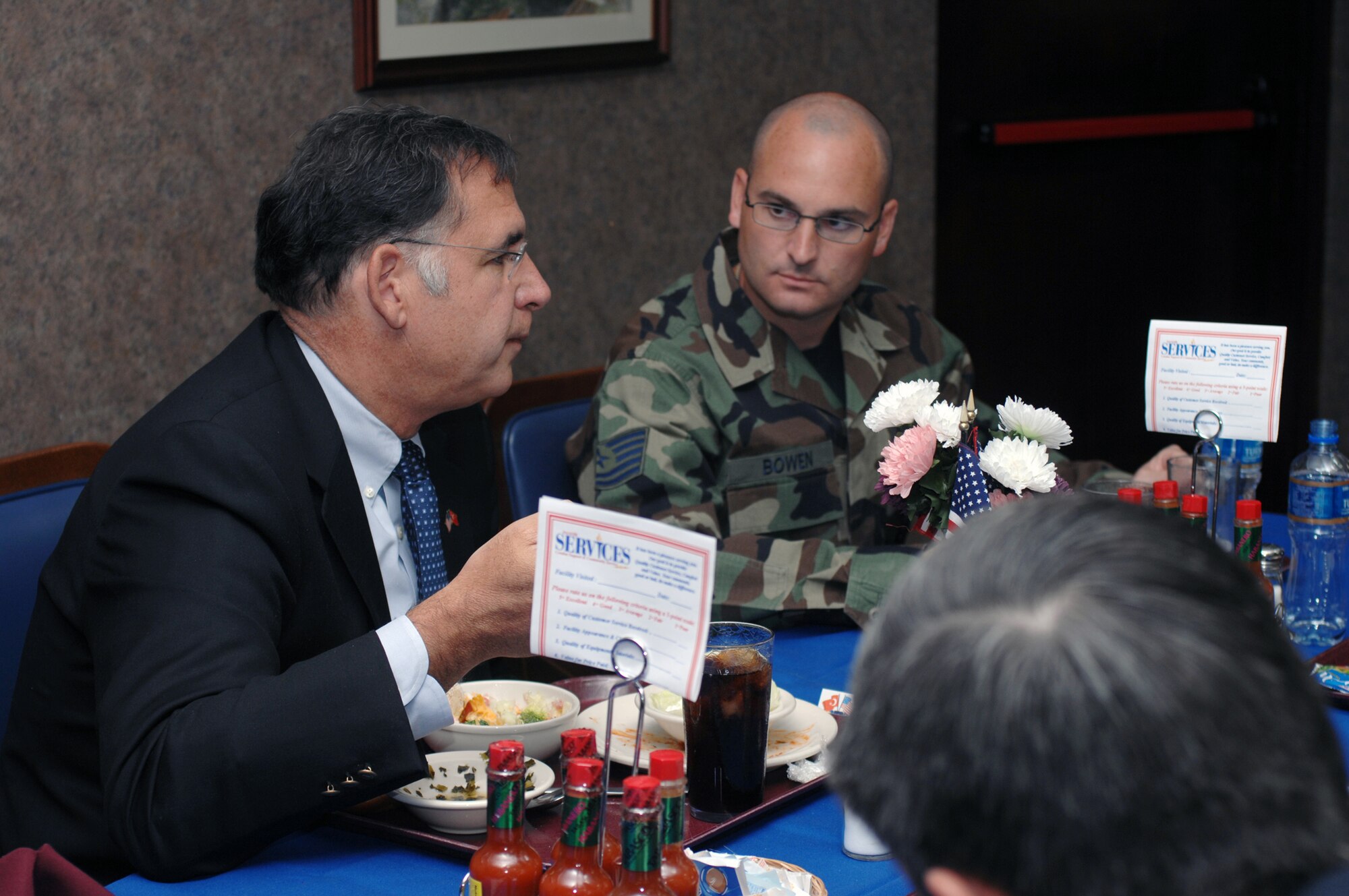 Tech. Sgt. Corey Bowen, 39th Operations Squadron, listens intently as Rep. John Boozman, third district of Arkansas, discusses political issues at a luncheon May 30 at the Sultan's Inn dining facility. The luncheon was part of a three-day visit by congressional delegates. (U.S. Air Force photo by Staff Sgt. Jeff Nevison)