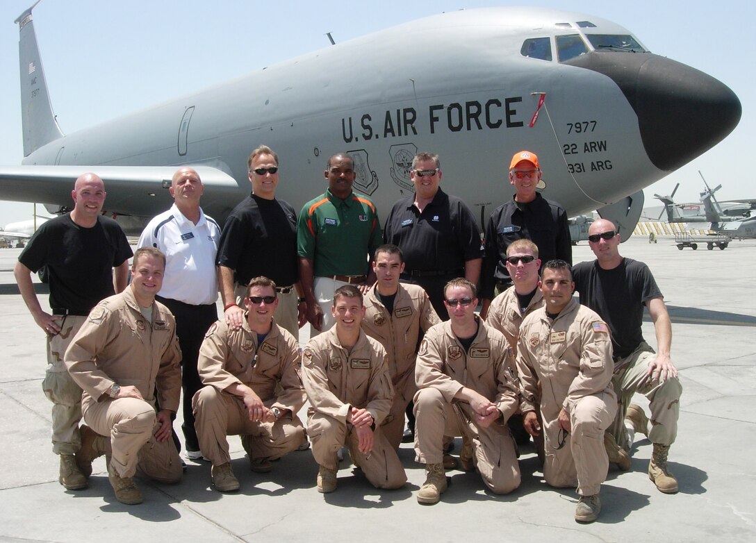 Four of the Airmen who recently helped fly five college football coaches to Southeast Asia were from the 931st Air Refueling Group.  The coaches (back row from left to right) included's Yale's Jack Siedlecki (with white shirt), Georgia's Mark Richt, Miami's Randy Shannon, Notre Dame's Charlie Weis, and Auburn's Tommy Tuberville (with orange hat). With Richt's hand on his shoulder is pilot and Atlanta, Ga., native Capt. Eric Junkins.  On the far left is Staff Sgt. Jon Barber (w black t-shirt), 931st Maintenance Squadron crew chief. Kneeling directly in front of Tuberville is Tech. Sgt. Chris Norris, boom operator, and in front of Norris is pilot Capt. Keith "Kip" Anderson (with sunglasses).  Captain Junkins, Captain Anderson and Sergeant Norris are members of the 18th Air Refueling Squadron, the flying squadron of the 931st ARG.  