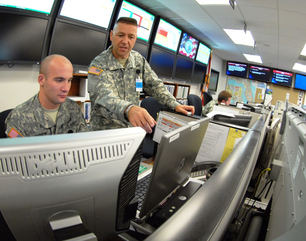 Army 1st Lt. Daniel Barrow, left, and Army Chief Warrant Officer Todd Berlinghof monitor the track of a simulated storm -- "Hurricane Herb" -- during an exercise at the Florida National Guard's Joint Emergency Operations Center in St. Augustine, Fla., June 2, 2008. Florida National Guard photo by Air Force Tech. Sgt. Thomas Kielbasa