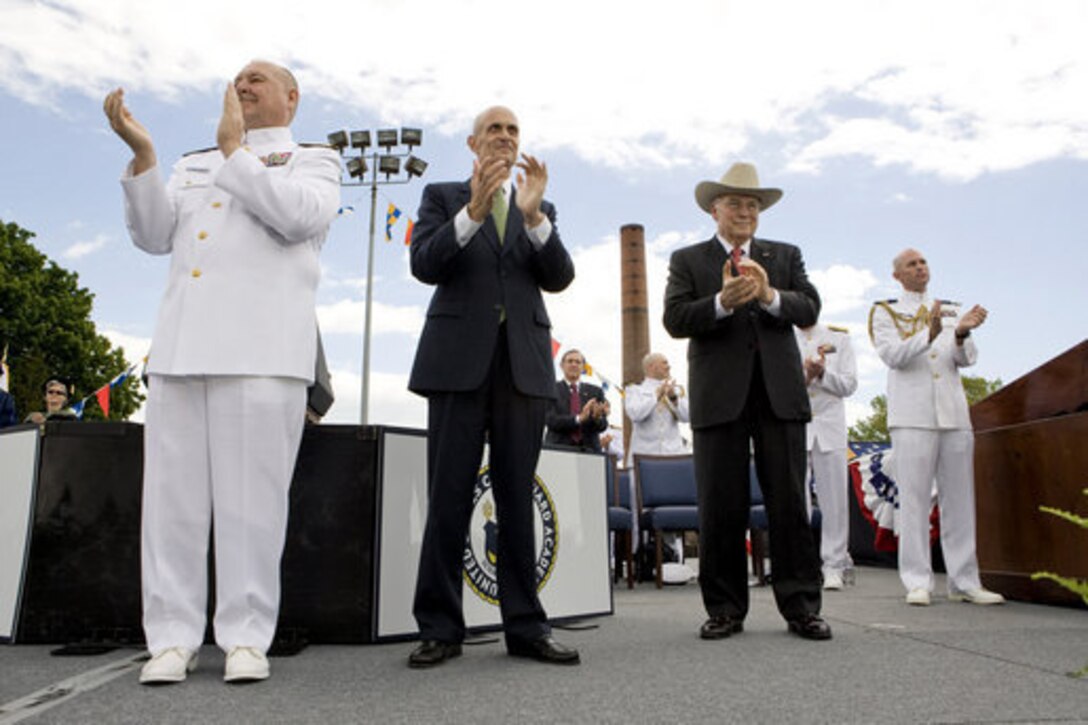 Vice President Dick Cheney is joined by Adm. Thad Allen, commandant of the U.S. Coast Guard, left, and Secretary of Homeland Security Michael Chertoff, center, in applauding the graduates of the U.S. Coast Guard Academy, May 21, 2008, during commencement exercises in New London, Conn. 