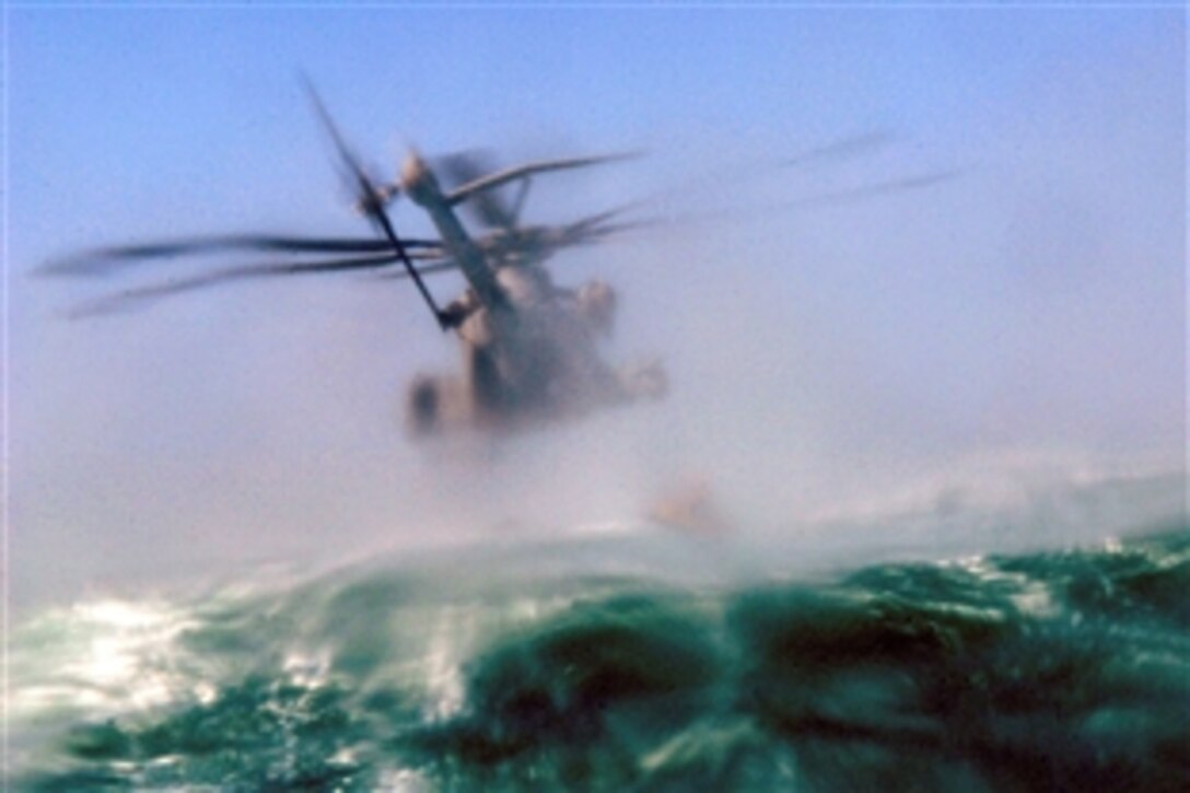 A MH-53 helicopter assigned to a Marine squadron flies low over the Gulf of Aden to drop a Zodiac boat and pararescuemen assigned to the 82nd Expeditionary Rescue Squadron during a training mission with Combined Joint Task Force-Horn of Africa, Gulf of Aden, May 31, 2008.   