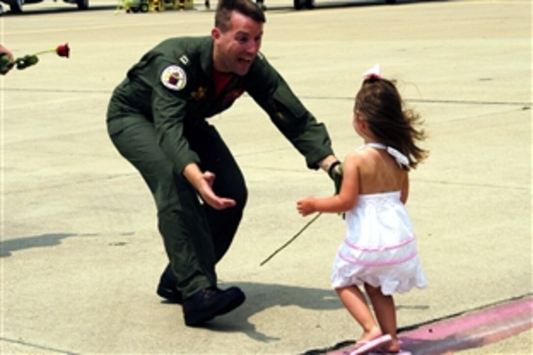 Navy Lt. David Camburn, assigned to the "Red Rippers" of Strike Fighter Squadron 11, greets his daughter after arriving home from a seven-month deployment aboard the Nimitz-class aircraft carrier USS Harry S. Truman, Virginia Beach, Va., May 31, 2008. 
