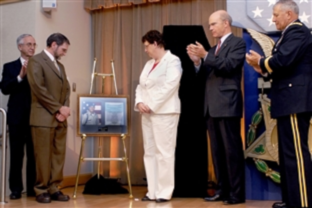 Deputy Defense Secretary Gordon England, left, Tom McGinnis, Romayne McGinnis, Army Secretary Pete Geren and Vice Chief of Staff of the Army Gen. Richard Cody stand by during the unveiling of a Pentagon Medal of Honor citation, June 3, 2008, in the Pentagon's Hall of Heroes. The Medal of Honor was presented posthumously to Army Pfc. Ross A. McGinnis for his selfless act of bravery on Dec. 4, 2006, while deployed in Baghdad.  His parents, Tom and Romayne McGinnis, accepted the award.