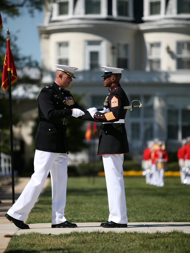 Sgt. Maj. Eric Stockton receives the non-commissioned officer sword from Col. Andrew Smith during a post and relief ceremony held at Marine Barracks Washington, April 14. Stockton, who replaces Sgt. Maj. Sylvester Daniels as the MBW sergeant major, recently transferred from Marine Corps Recruit Depot Parris Island, S.C.