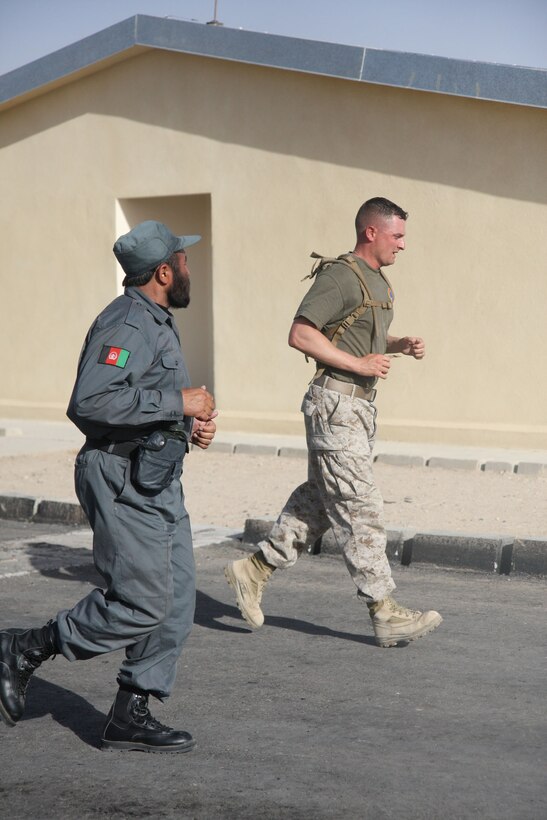 Jason E. Pearson, Weapons Company 1st Sergeant, 2nd Battalion, 7th Marine Regiment, leads Afghan National Police recruits in physical training aboard Lashkar Gah, June 3. 2nd Battalion, 7th Marines, based out of Marine Air Ground Combat Center 29 Palms, is a reinforced light infantry battalion deployed to Afghanistan in support of Operation Enduring Freedom.