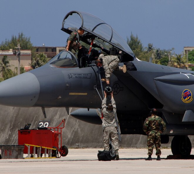 A U.S. Air Force F-15E Strike Eagle ground crew help pilots exit the jet at  Andersen Air Force Base, Guam, on June 4 from the 389th Fighter Squadron, Mountain Home Air Force Base, Idaho. A total of twelve F-15's are deployed to Andersen for a four month long tour. (U.S. Air Force by Airman 1st Class Courtney Witt) 