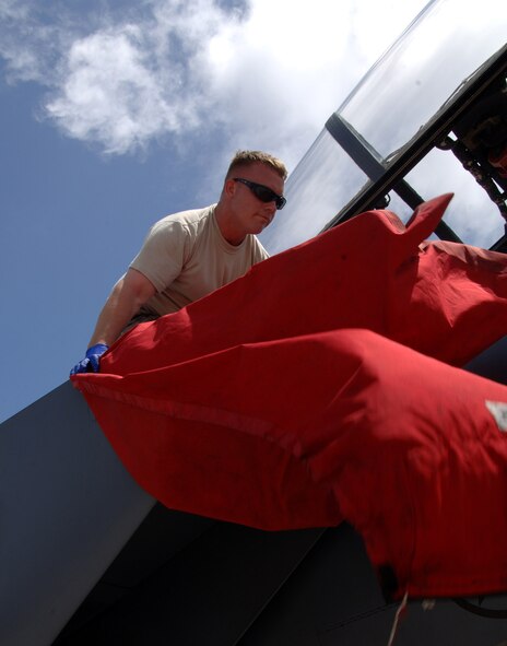 A U.S. Air Force F-15E Strike Eagle ground crew Staff Sergeant Billy Williams of the 389th Aircraft Maintenance Group puts on intake covers after the flight at Andersen Air Force Base, Guam, on June 4 from the 389th Fighter Squadron, Mountain Home Air Force Base, Idaho. A total of twelve F-15's are deployed to Andersen for a four month long tour. (U.S. Air Force by Airman 1st Class Courtney Witt) 