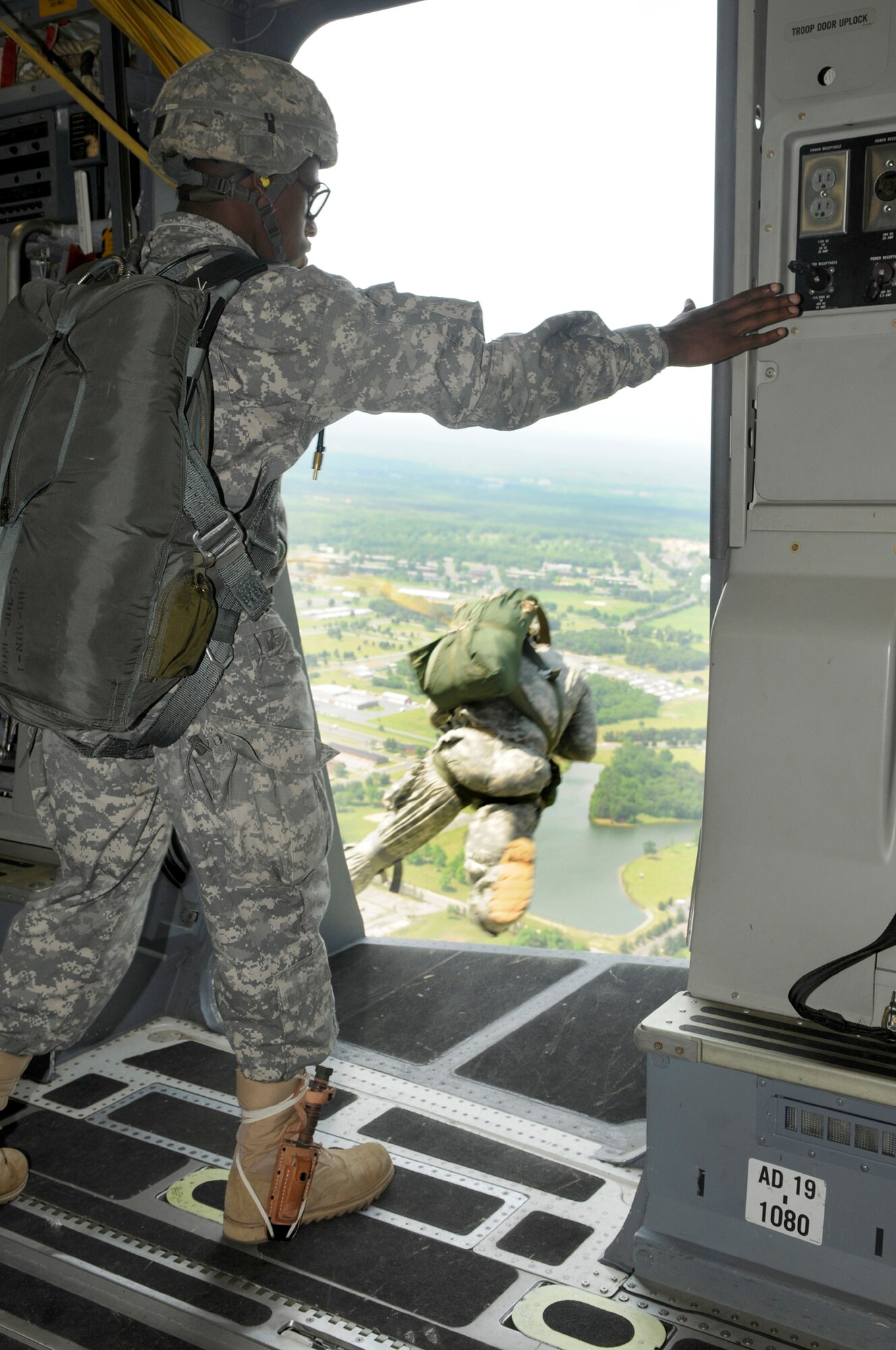 Army Staff Sgt. Montrell Kea, 82nd Airborne Division jumpmaster, Fort Bragg, N.C., watches as Staff Sgt. Michael Pinheiro jumps out of a C-17 Globemaster III to start off the 2008 McGuire Air Expo held May 31 and June 1. Other performances included the U.S. Air Force Thunderbirds, F-15 E Strike Eagle Demonstration, Matt Chapman and the Geico Skytypers. McGuire’s own KC-10, C-17 and KC-135 were also on display for the 170,000 guests.  The 2008 McGuire Air Expo culminated the events of Air Force Week in Philadelphia held May 26-June 2. For more photos, see pages XX.(U.S. Air Force photo/Kenn Mann)