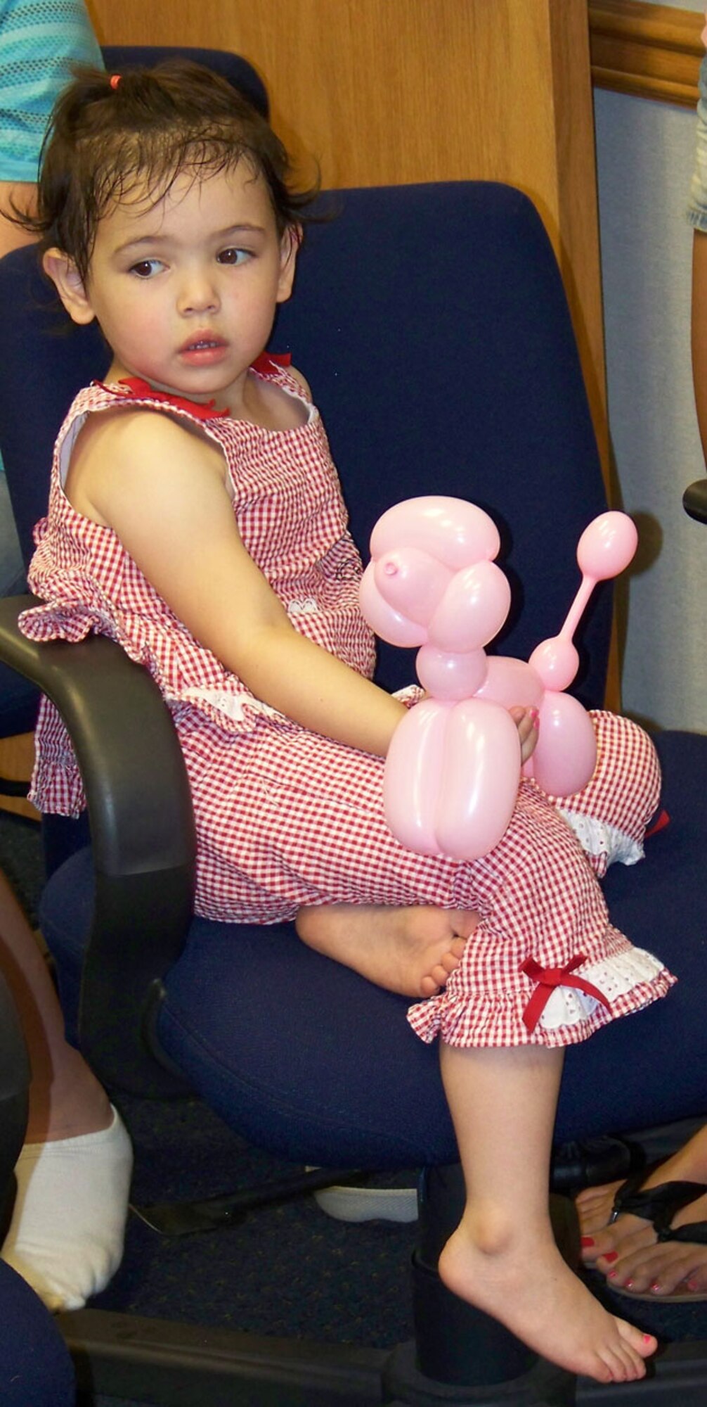 Sarah Smith, daughter of Tech. Sgt. Steve Smith, 917th Security Forces Squadron, sits with her balloon puppy during the 917th Security Forces Family Day, Wednesday, June 4, at the 917th Security Forces Squadron building, Barksdale AFB, La. (U.S. Air Force photo/Master Sgt. Sherri Bohannon)