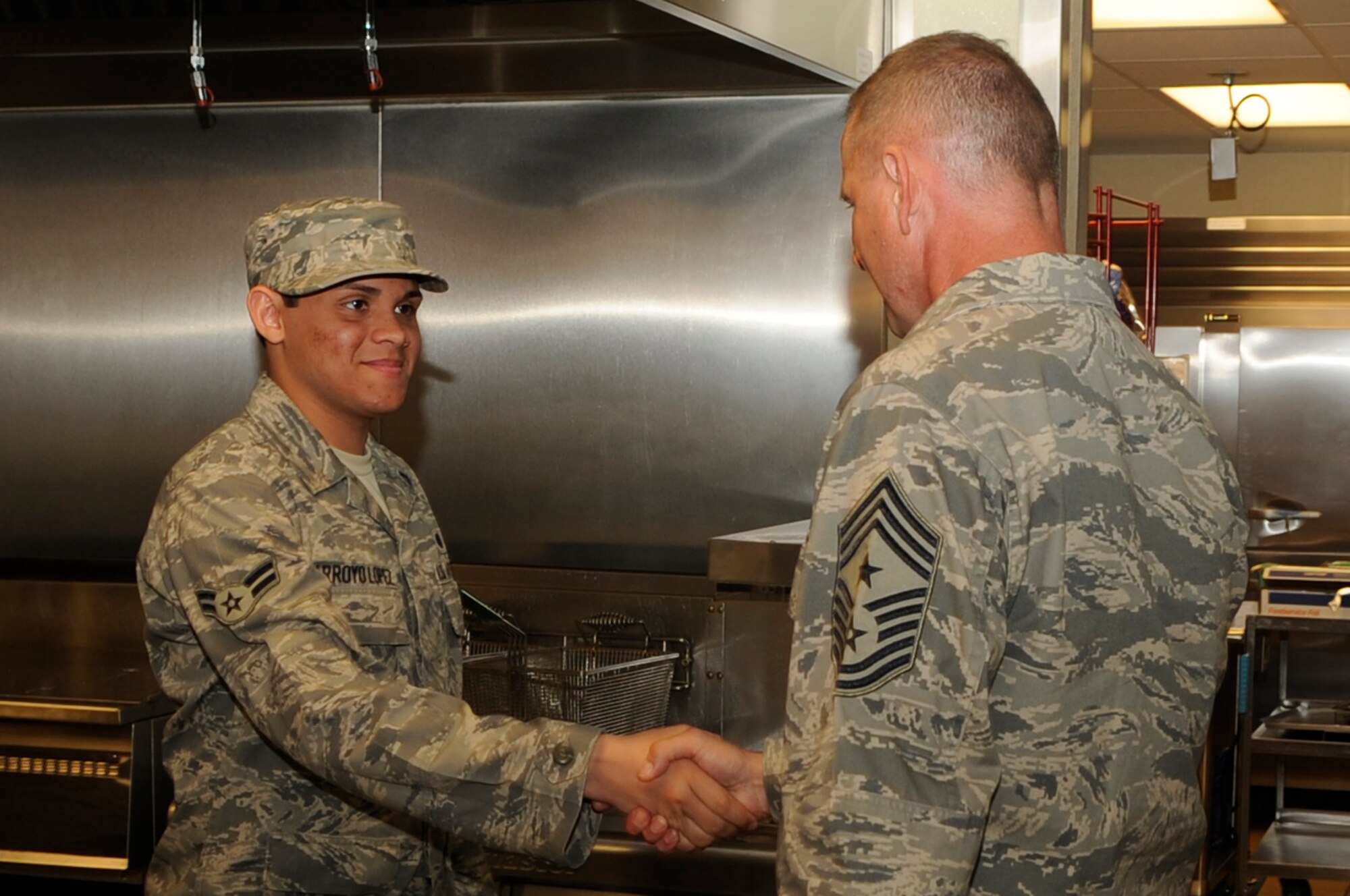 Chief Master Sgt. Lloyd Hollen, 12th Air Force command chief, meets Airman 1st Class Jose Arroyo Lopez, 28th Force Support Squadron food service apprentice, during his visit here June 1 through 3. Chief Hollen visited Ellsworth to meet Airmen as the new 12 AF command chief. (U.S. Air Force photo/Airman 1st Class Kasey Zickmund)