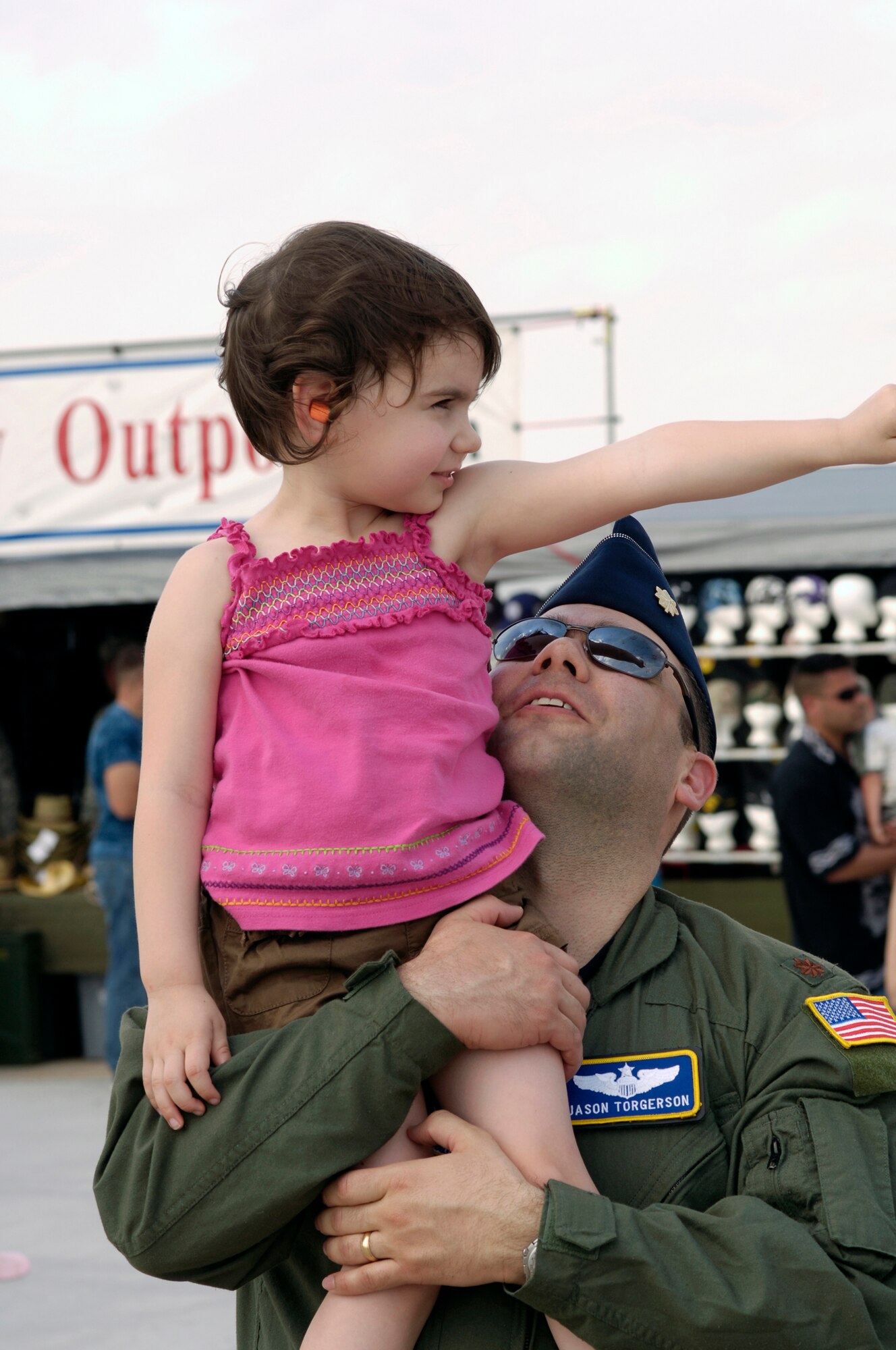Maj. Jason Togerson, 305th Air Mobility Wing Command Post, McGuire Air Force Base, N.J., and his daughter Megan, 4, watch the U.S. Air Force Thunderbirds perform their aerial maneuvers during the 2008 McGuire Air Expo held May 31 and June 1. The 2008 McGuire Air Expo culminated the events of Air Force Week in Philadelphia held May 26-June 2. (U.S. Air Force photo/Kenn Mann)