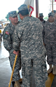 Lt. Col. Richard Somers takes the Army Forces unit colors from Col. Marcus De Oliveira, Joint Task Force-Bravo commander, during a change of command ceremony June 4 at Soto Cano Air Base, Honduras. The former ARFOR commander, Lt. Col. Gregory Jicha, moves to his new assignement at the United States Army Special Operations Command. ARFOR executes command and control and provides logistical and adminustrative support to JTF-Bravo and other Army or joint operations in Central America. (Photo by Martin Chahin)