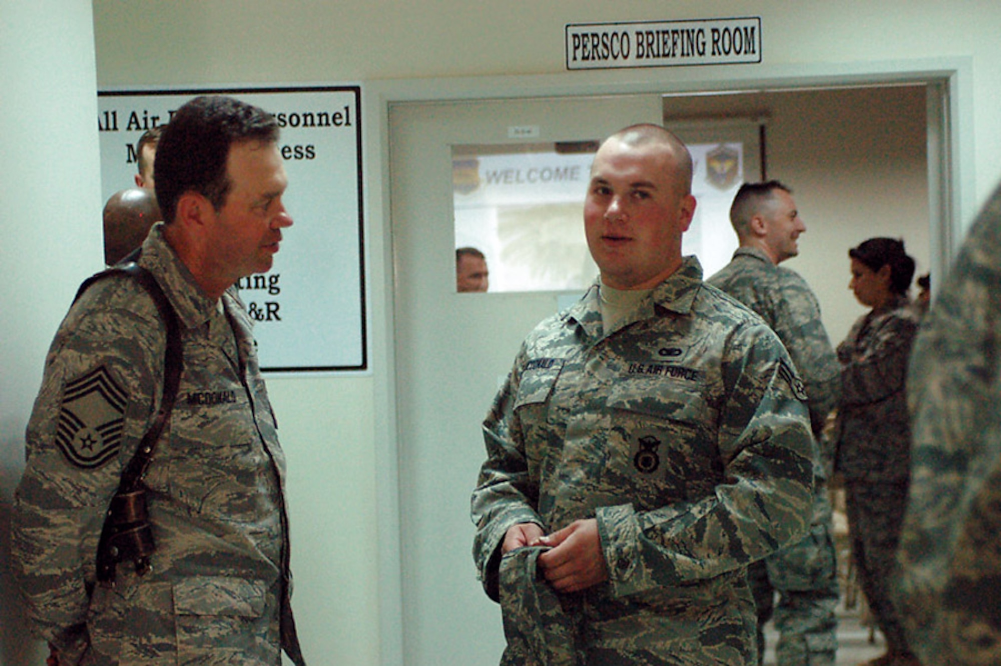 Chief Master Sgt. Earl McDonald speaks with his eldest son, Airman 1st Class Phil McDonald, March 13 upon his arrival to Sather Air Base, Iraq. Chief McDonald is the 447th Expeditionary Civil Engineer Squadron superintendent, and Airman McDonald is assigned to the 447th Expeditionary Security Forces Squadron. (U.S. Air Force photo/Tech. Sgt. Amanda Callahan) 
