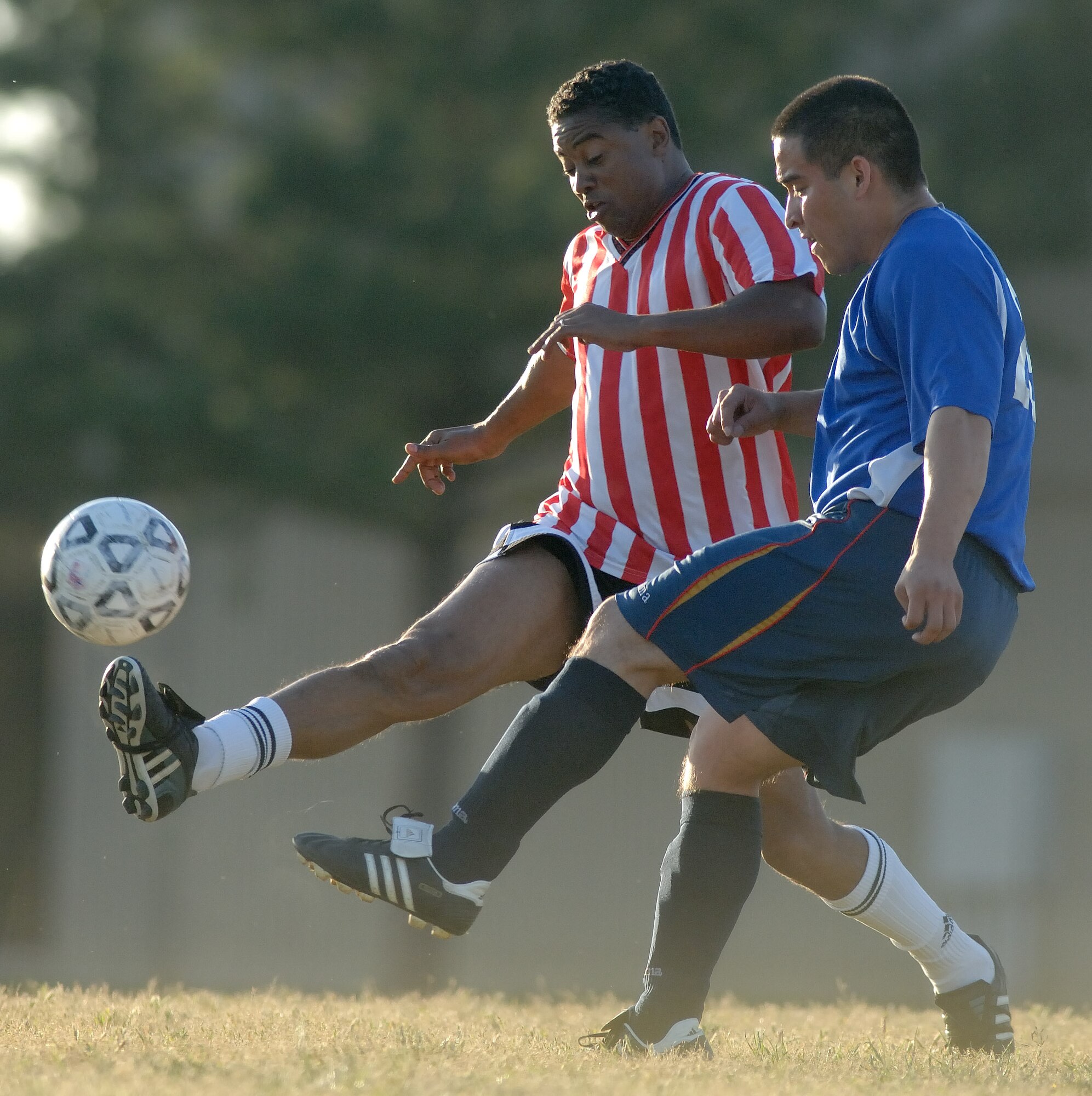 LANGLEY AIR FORCE BASE, Va. -- Garth Elliot (left), 1st Medical Surgical Squadron, and Staff Sgt. Julio Alarcon (right), 735th Air Force Material Command, compete for the ball during the intramural soccer championship May 29.  The 1st Logistics Readiness Squadron defeated the 1st Medical Surgical Squadron with a score of 2 to 0 and became Langley's intramural soccer champions. (U.S. Air Force photo/Senior Airman Barry Loo)