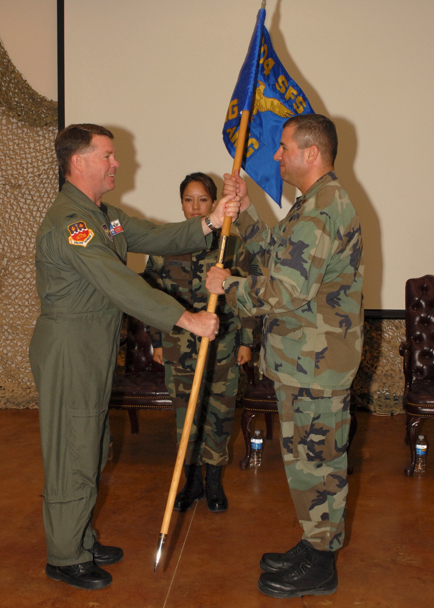 Col. John F. Nichols, Commander of the 149th Fighter Wing formally turns command of the Texas Air National Guard’s, 204th Security Forces Squadron in El Paso, Texas over to Maj. Carl Alvarez in a ceremony May 31, 2008.  The passing of the Squadron’s flag symbolizes the unbroken exchange of command from one commander to another. 