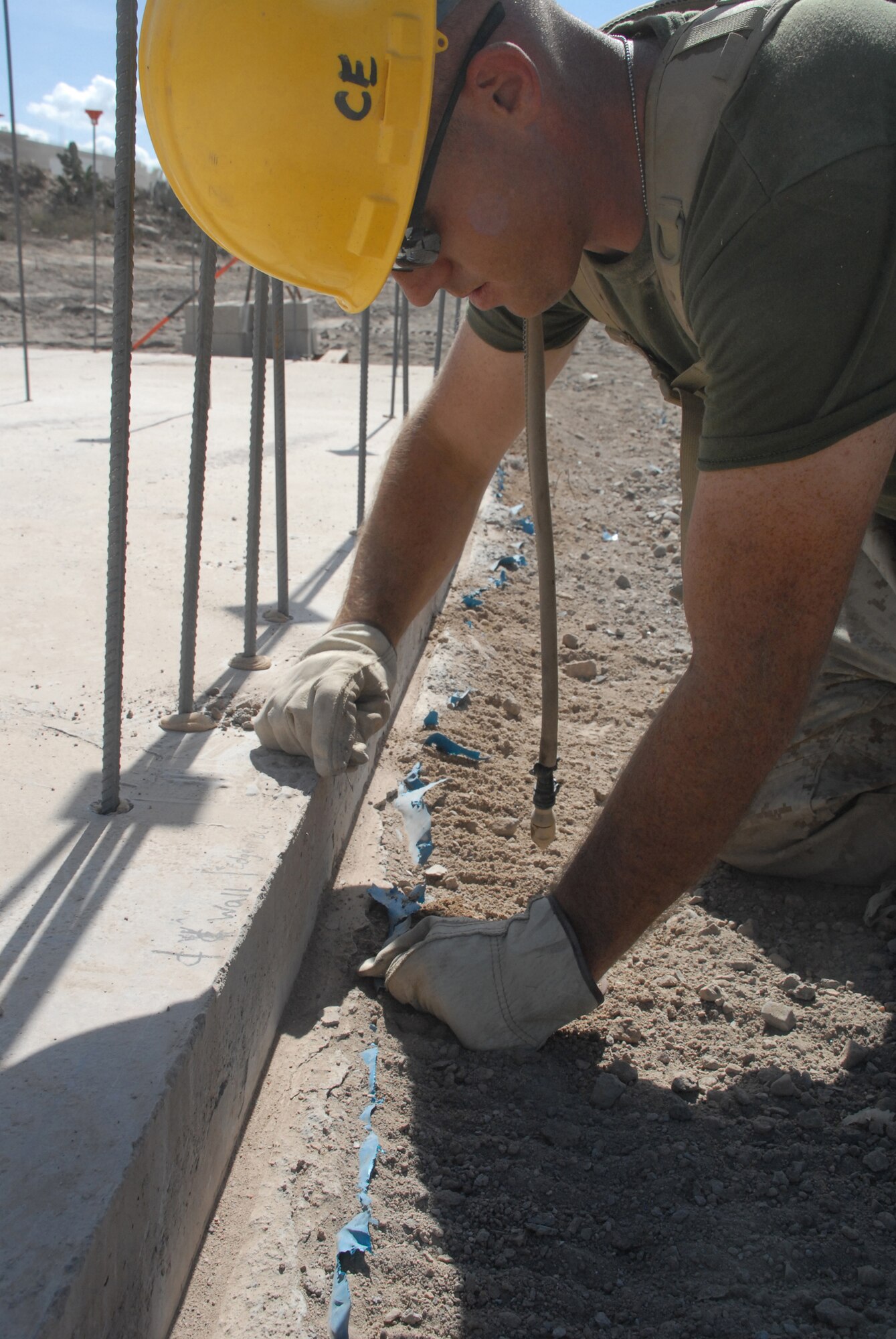 U.S. Marine Lance Cpl. Christopher Johnson, a combat engineer deployed from the Marine Wing Support Squadron 472, Detachment Bravo at Westover Air Reserve Base, Mass., removes excess poly from the edges for a school being built in Yanamilla, Peru in support of New Horizons Peru 2008, a humanitarian event that benefits thousands of Peruvians. Nearly 300 members from the U.S. Air Force, Army, Marines, and Navy came together to provide Peruvians with new schools, clinics, and water wells. (U.S. Air Force photo/Airman 1st Class Tracie Forte)