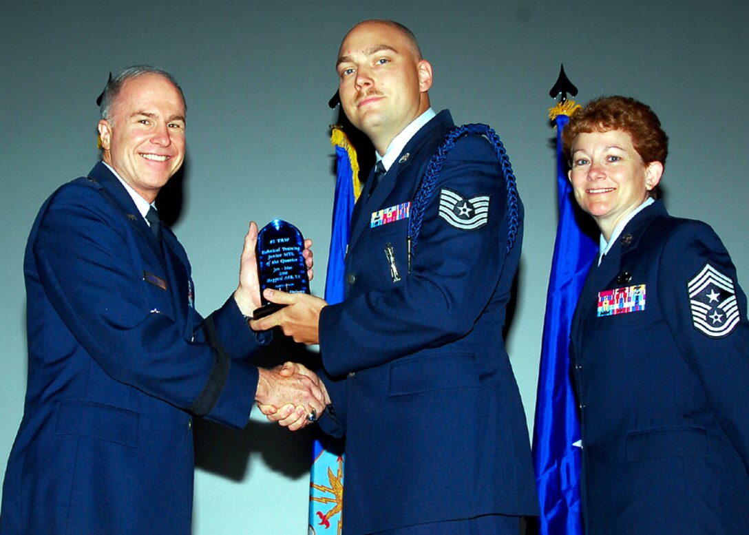 Brig. Gen. Richard Devereaux, 82nd Training Wing commander, presents Tech. Sgt. George Springer, 362nd Training Squadron, with the Junior Military Training Leader of the Quarter award, June 2. (U.S. Air Force photo/Harry Tonemah) 