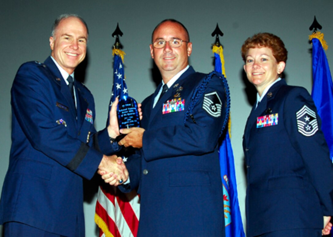 Brig. Gen. Richard Devereaux, 82nd Training Wing commander, presents Master Sgt. Robert Smith, 361st Training Squadron, with the Senior Military Training Leader of the quarter award, June 2. (U.S. Air Force photo/Harry Tonemah) 