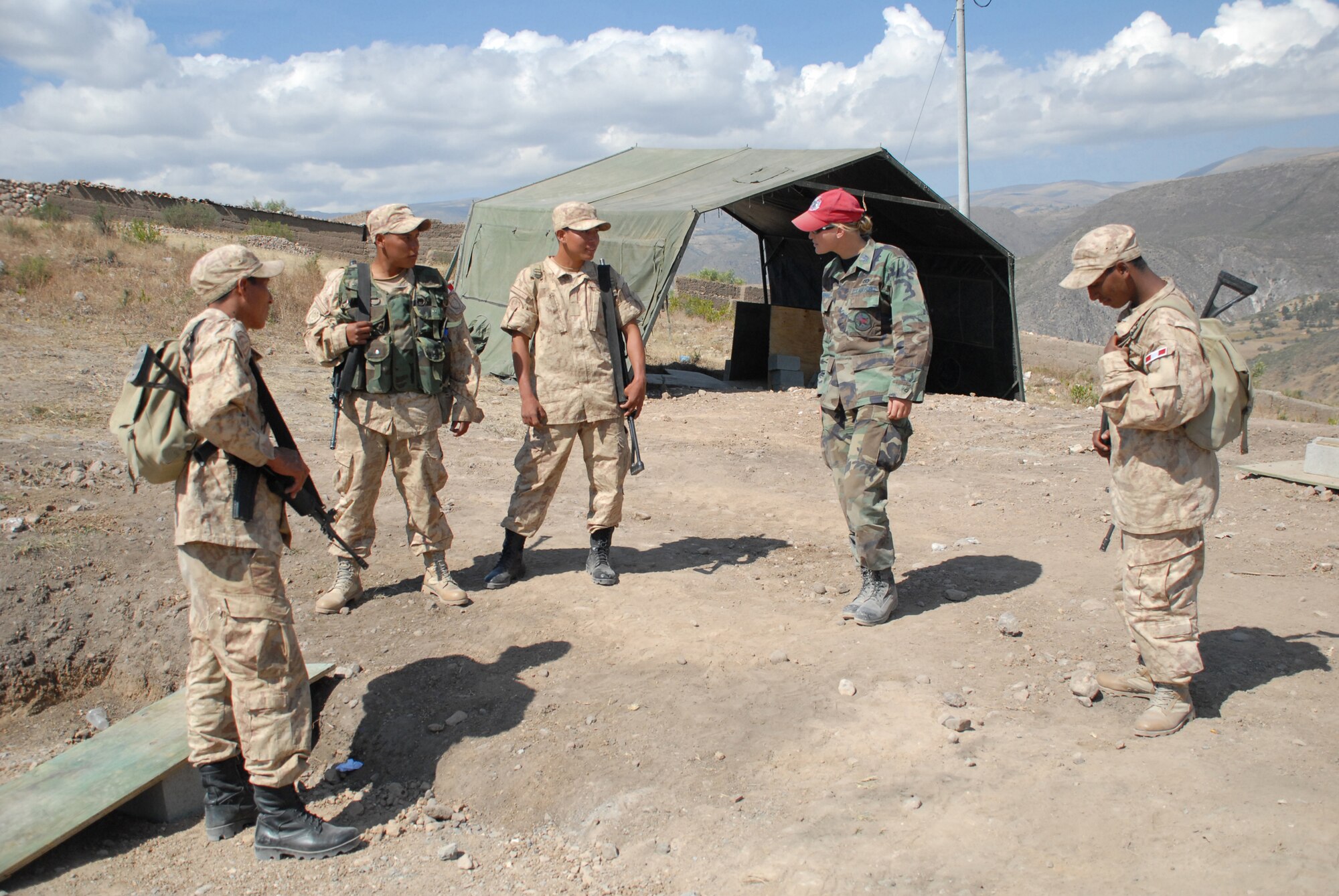 U.S. Air Force Captains Stacy Nimmo, deployed from the 820th RED HORSE Squadron at Nellis Air Force Base, Nev., finds out about life in the Peruvian military during a visit to the construction site for a school being built in support of New Horizons Peru 2008, a humanitarian event that benefits thousands of Peruvians. Nearly 300 members from the U.S. Air Force, Army, Marines, and Navy came together to provide Peruvians with new schools, clinics, and water wells. (U.S. Air Force photo/Airman 1st Class Tracie Forte)