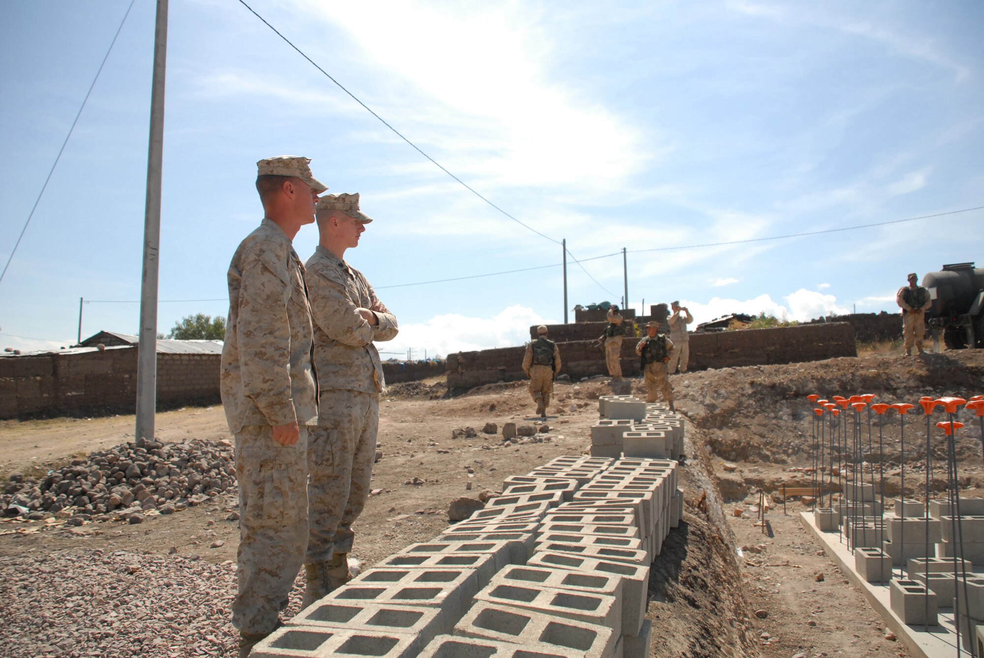 U.S. Marine Staff Sgt. Todd Bowers and Sgt. Alan Parvis, civil affairs specialists with the 4th Civil Affairs Group at Anacostia Naval Annex, District of Columbia, go over the construction site plans for a school being built in support of New Horizons Peru 2008, a humanitarian event that benefits thousands of Peruvians. Nearly 300 members from the U.S. Air Force, Army, Marines, and Navy came together to provide Peruvians with new schools, clinics, and water wells. (U.S. Air Force photo/Airman 1st Class Tracie Forte)