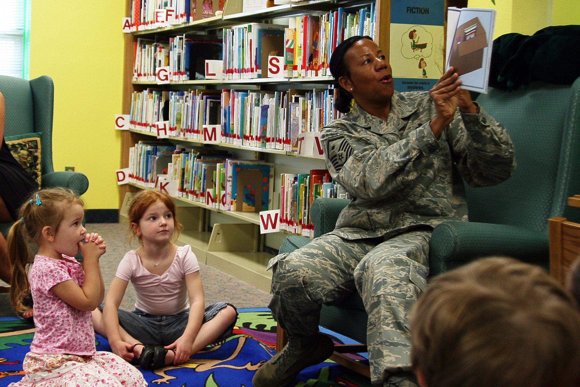 Master Sgt. Juanita Crain entertains children during military story time at the Eglin Base Library.