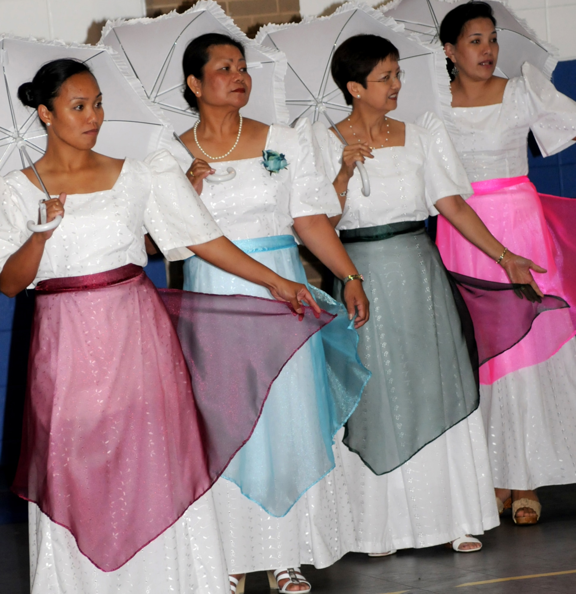 From left, Senior Airman Norites Bitig, 81st MDSS; Fe Fletcher of Biloxi, Cindy Morrone and Bernadette Goodness perform “polka sa plaza,” a Filipino dance.  Mrs. Morrone is married to Michael Morrone, 334th Training Squadron.  (U.s. Air Force photo by Kemberly Groue)