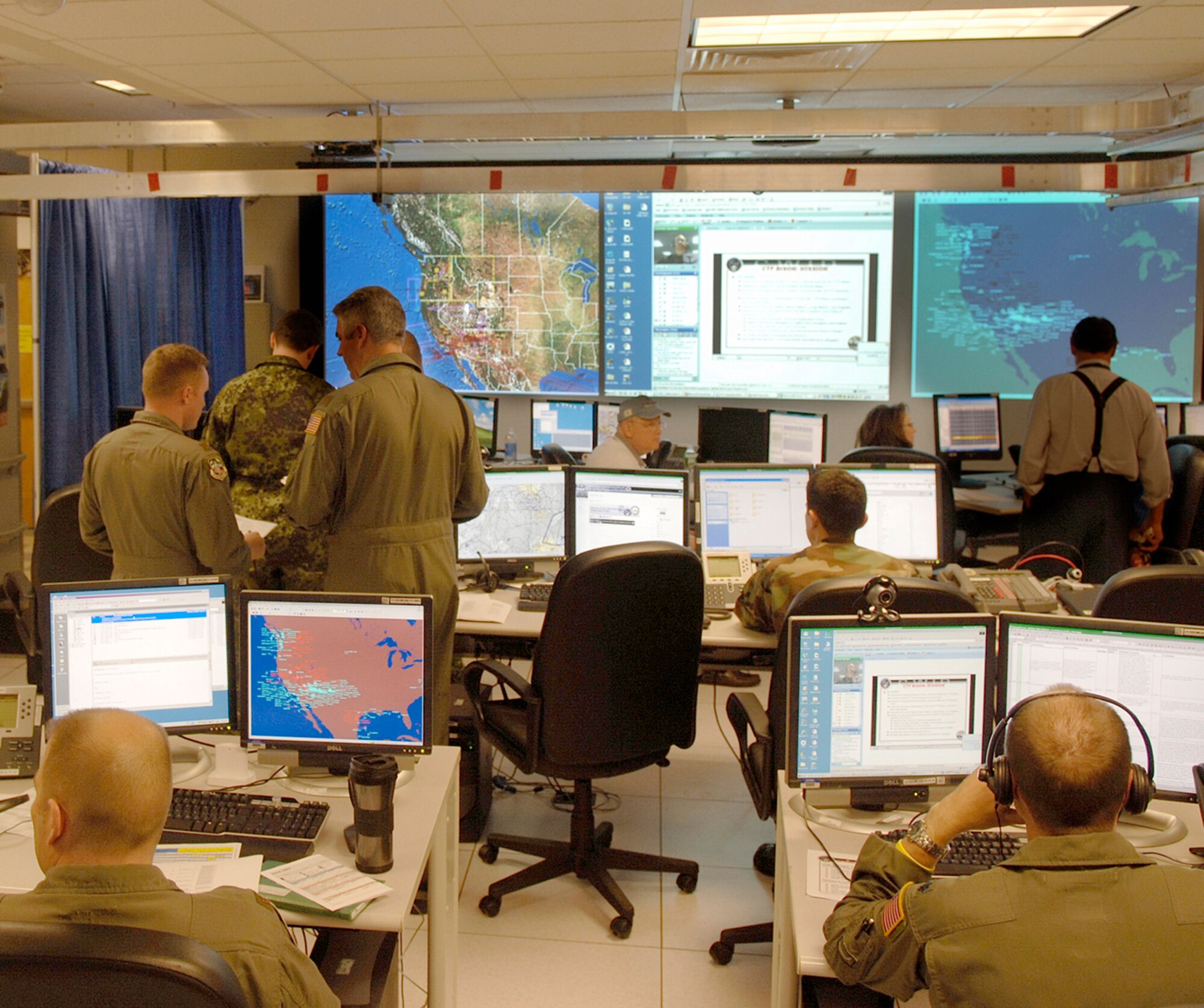 HANSCOM AFB, Mass. -- U.S. Air Force active duty, Guard and Reserve members participating in last year’s Coalition Warrior Interoperability Demonstration join coalition forces on the floor of a mock Combined Air Operations Center at Hanscom  in June 2007.  Participants are now gathering to set up at the Hanscom site, as well as at many other sites around the globe, to prepare for this year’s demonstration, which kicks off June 9.  ( U.S. Air Force photo by Jan Abate)