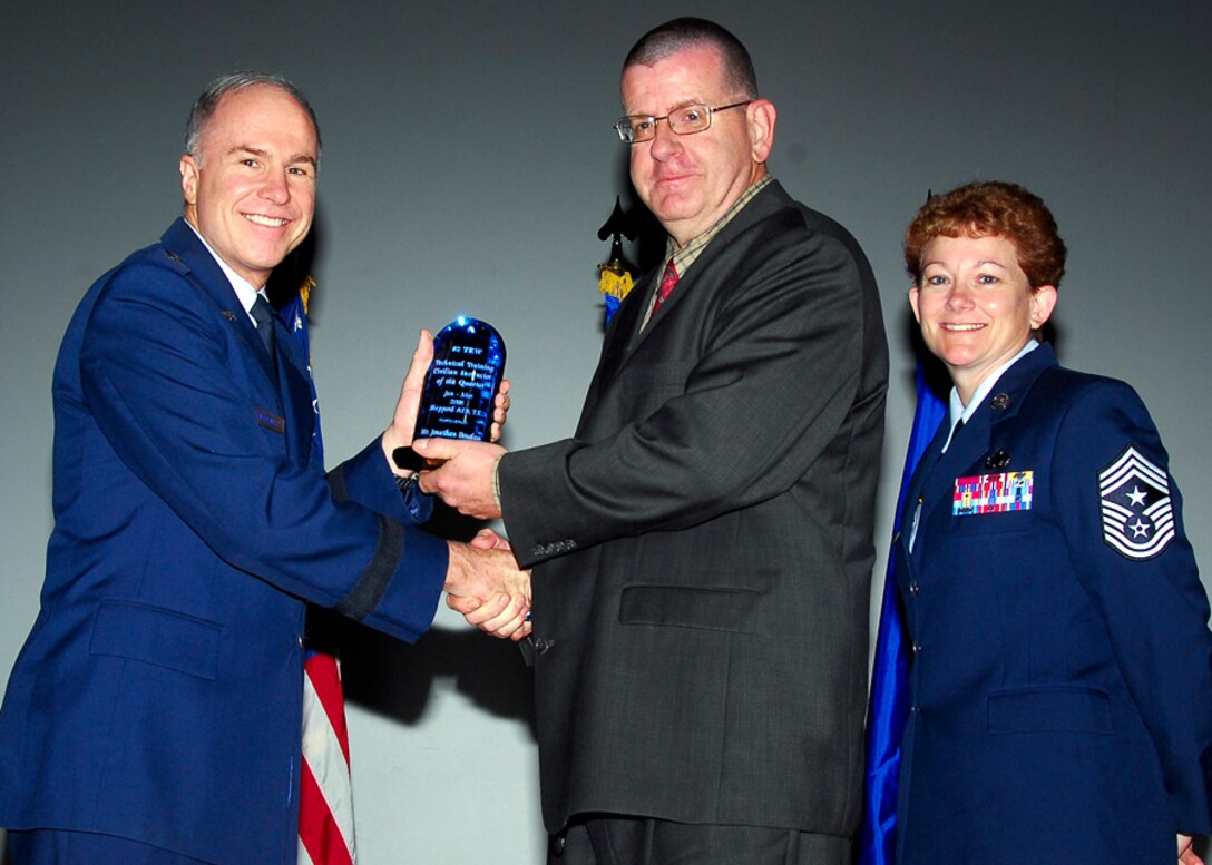 Brig. Gen. Richard Devereaux, 82nd Training Wing commander, presents Jonathan Douglas, 360th Training Squadron, with the Civilian Instructor of the Quarter award June 2. (U.S. Air Force photo/Harry Tonemah) 