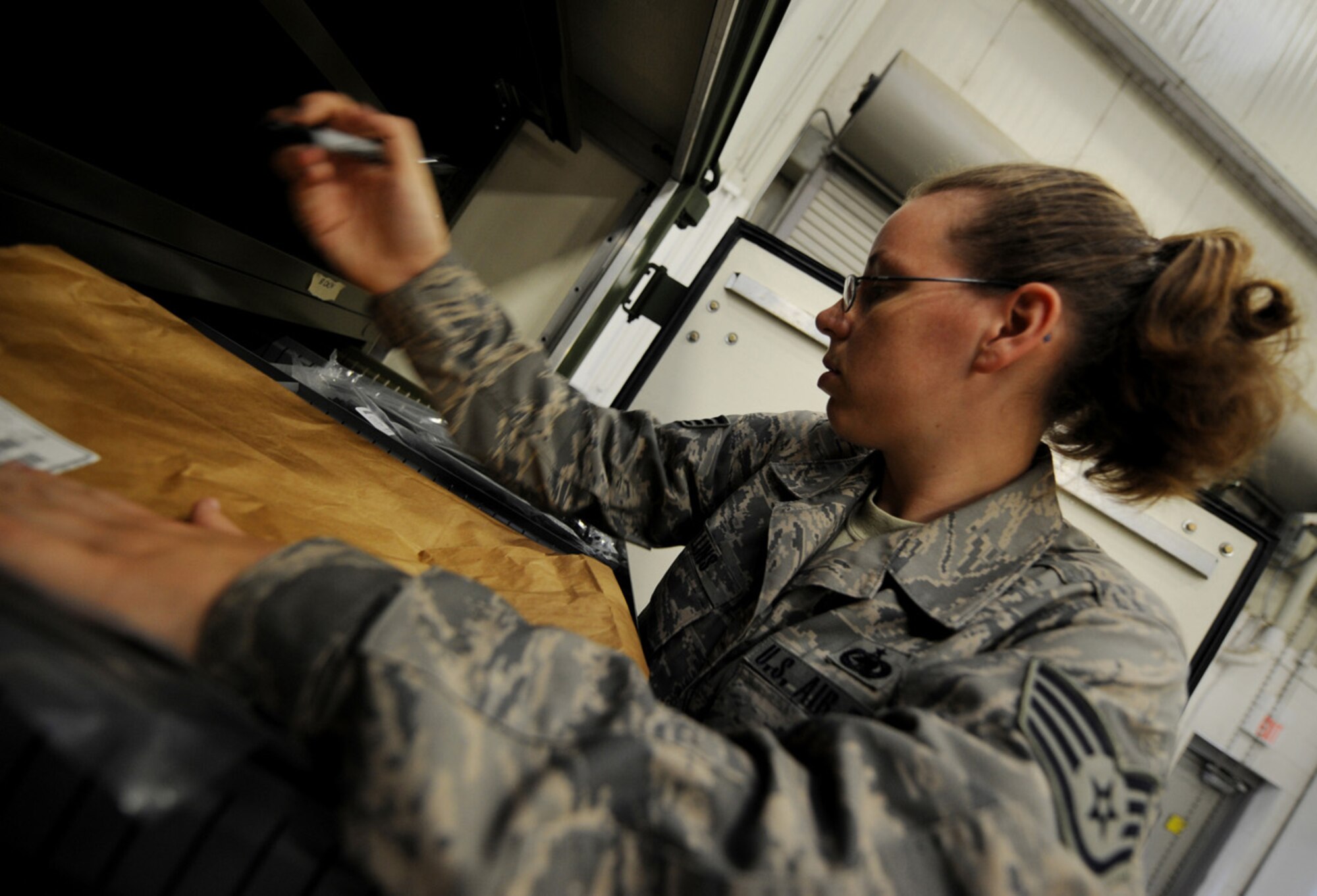 MOODY AIR FORCE BASE, Ga. -- Staff Sgt. Sandra Mullins, 23rd Logistics Readiness Squadron supply apprentice, puts parts away after they have been verified for correct amounts here June 3. The parts are being stored for a future deployment. (U.S. Air Force photo by Senior Airman Gina Chiaverotti) 