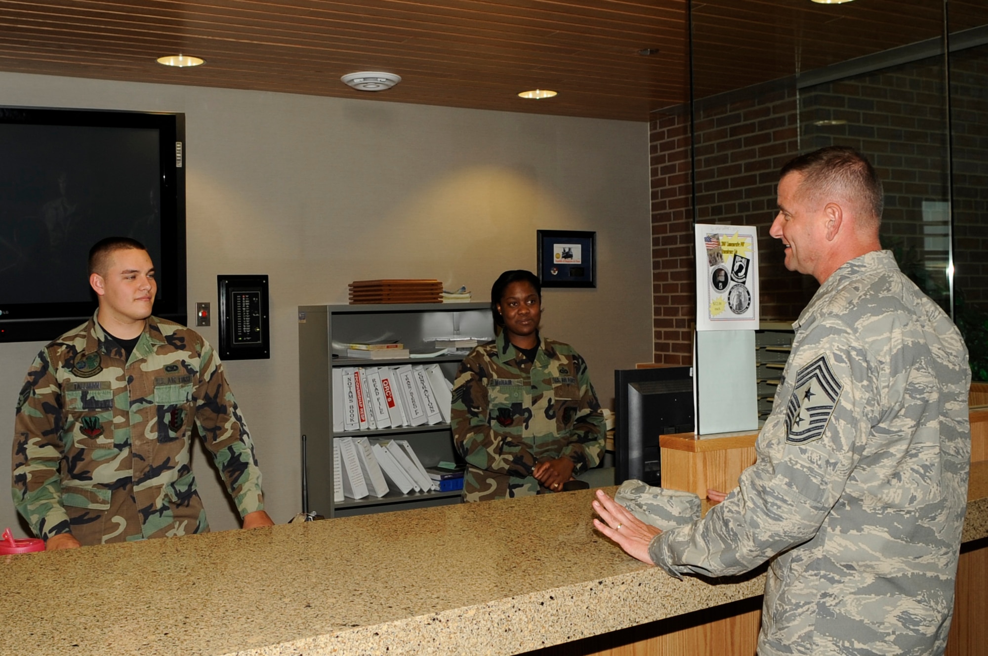 Chief Master Sgt. Lloyd Hollen, 12th Air Force command chief, meets Staff Sgt. LaDonna McNair (center), 28th Operations Support Squadron air field management operations supervisor, and Airman 1st Class Benjamin Tallman, 28 OSS air field management shift leader, during his visit to Ellsworth June 1 to 3. (U.S. Air Force photo/Airman 1st Class Kasey Zickmund)