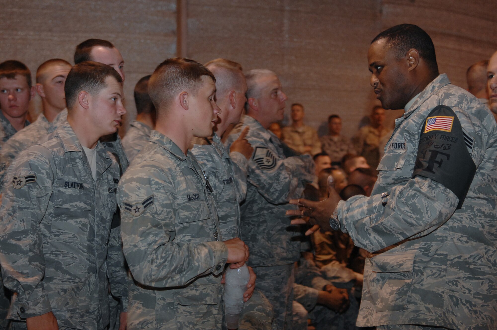 BALAD AIR BASE, Iraq -- Chief Master Sgt. John Carter III, 332nd Expeditionary Security Forces Squadron first sergeant, talks with Airmen from his unit during a promotion and awards ceremony here, May 31. Chief Carter who also serves as a first sergeant at his home station, is a Guardsman deployed from Bradley Air National Guard Base in East Grandby Conn. As a first sergeant, also known as a ?shirt?, Chief Carter is responsible for ensuring Airmen are well taken care of, both on and off-duty. (U.S. Air Force photo /Senior Airman Julianne Showalter)