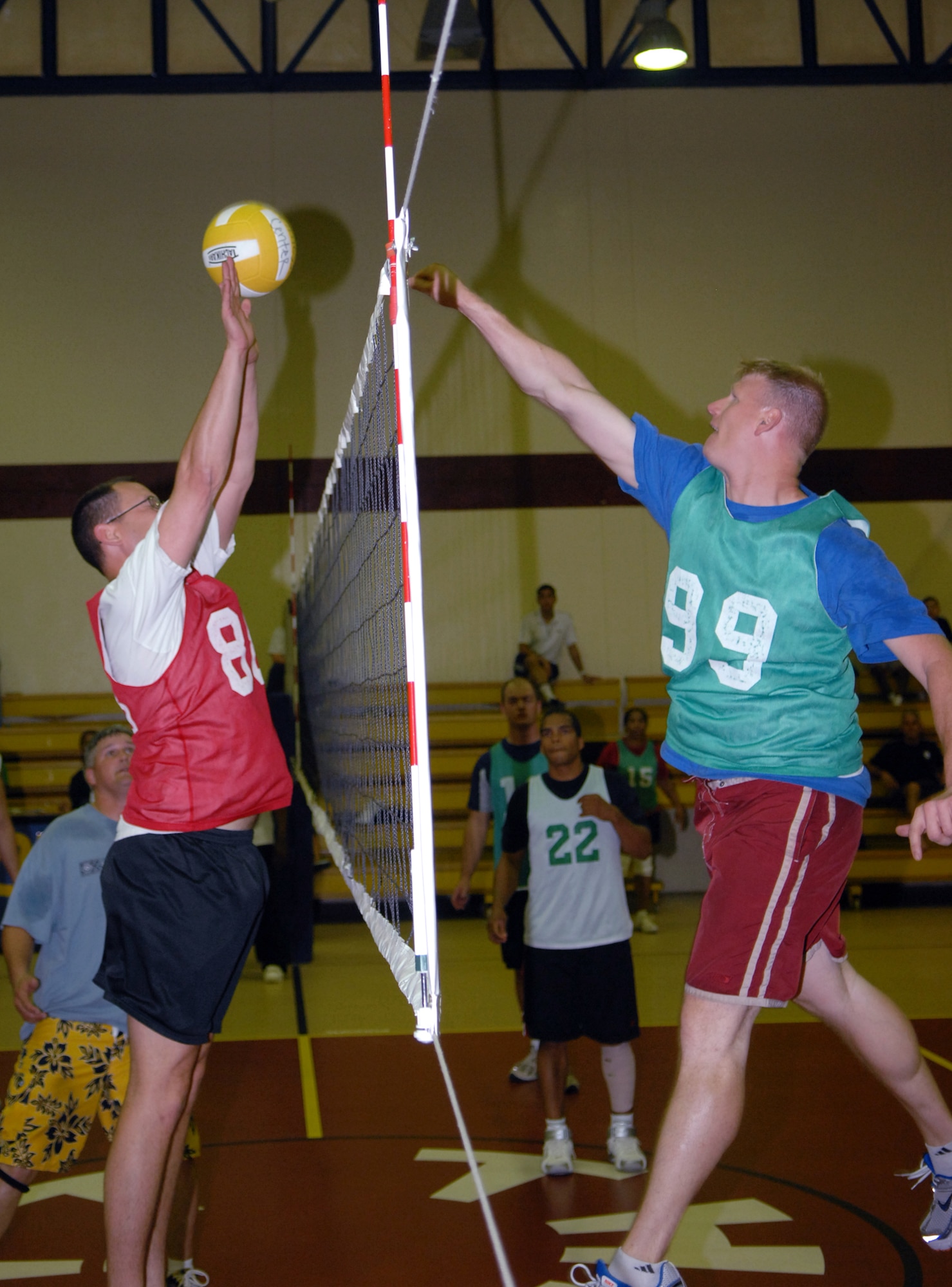 Jason Allen (right), 39 CES team, hits the ball over Jefferson Brown (left), 39 ABW team, to score a point during the first set of the second game. 
