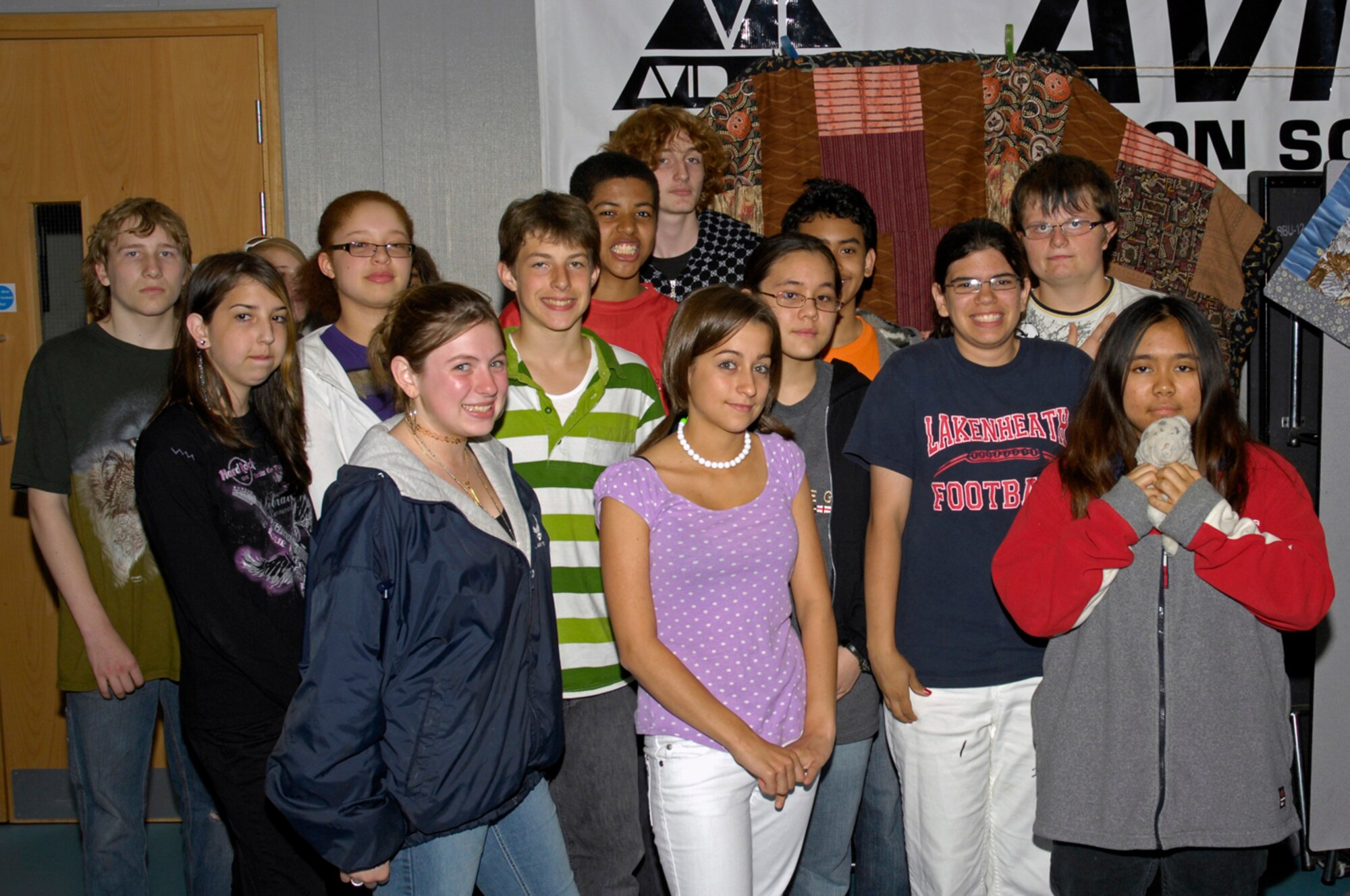 Mrs. Bruce's Family Consumer Science class stands in front of one of four quilts that will be donated to the " Home of the Brave Quilt Project" May 28 at the Lakenheath Middle School, RAF Feltwell, England. The Home of the Brave Quilt Project has presented more than 2,130 homemade quilts to the family members of fallen heroes, who gave their lives in service to their country, primarily during the Global War on Terror. (U.S. Air Force photo by Airman Perry Aston)