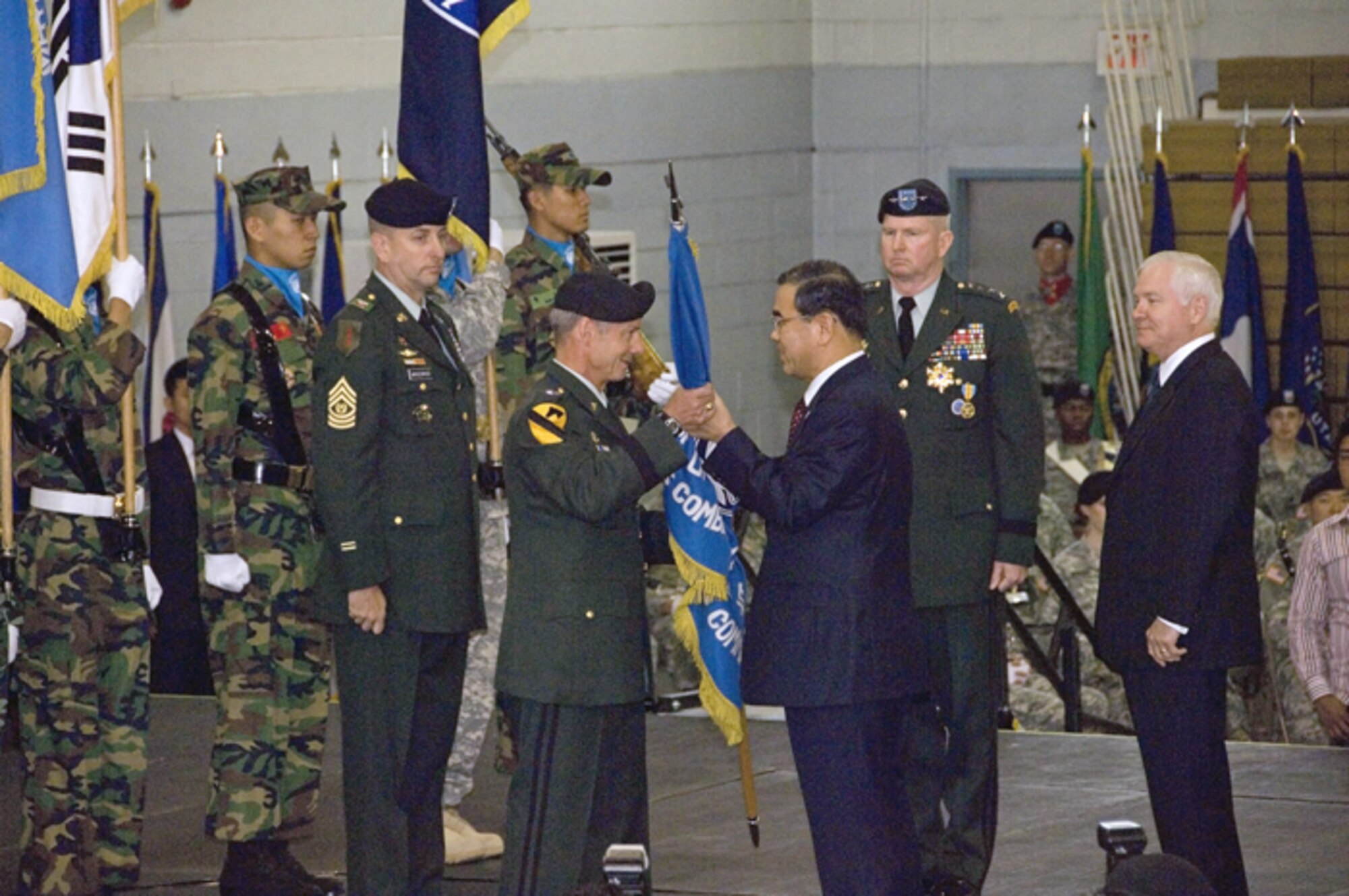 Army Gen. Walter L. Sharp, center, accepts the Republic of Korea/U.S. Combined Forces Command flag from Lee Sang-hee, ROK Defense minister during the USFK change of command ceremony Tuesday. General Sharp replaces Army Gen. B.B. Bell, who is retiring after 39 years of service. In addition to commanding USFK, General Sharp also assumed command of United Nations Command and Combined Forces Command. (U.S. Army photo/Spc. Kelly Lowery)