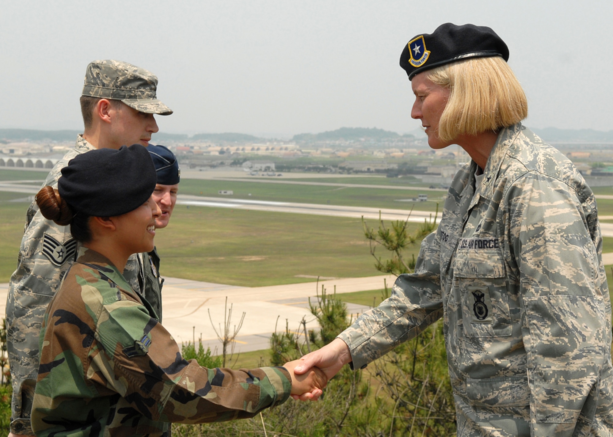 KUNSAN AIR BASE, Republic of Korea -- Brigadier General Mary Kay Hertog, Director of Security Forces, shakes hands with Airman 1st Class Jannete Meireles, 8th Security Forces Squadron force response leader, here June 4. General Hertog visited the Wolf Pack to discuss upcoming changes that directly affect security forces Airmen. (U.S. Air Force photo/Senior Airman Giang Nguyen)