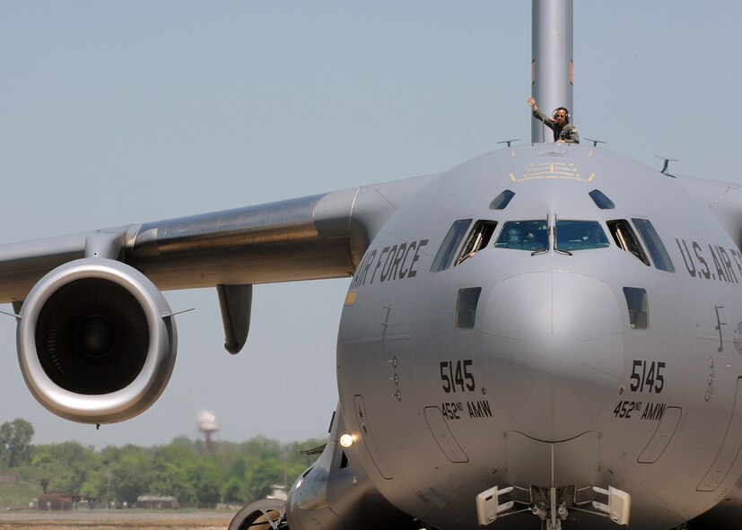 U.S. Air Force C-17 crew from March Air Force Base wave to an Air Show crowd after their performance at Barksdale Air Force Base, Louisiana, on April 21, 2007. The crew was visiting as part of the Defender's of Liberty Air Show 2007. (U.S. Air Force photo by Airman 1st Class Joanna M. Kresge)