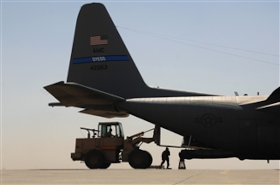 U.S. Air Force airmen with the 777th Expeditionary Airlift Squadron load cargo into a C-130 Hercules aircraft at Balad Air Base, Iraq, on May 10, 2008.  The squadron estimates it has prevented approximately 10,000 convoy vehicles and 27,000 service members from traveling along improvised explosive device laden roads since standing up in January of 2006.  