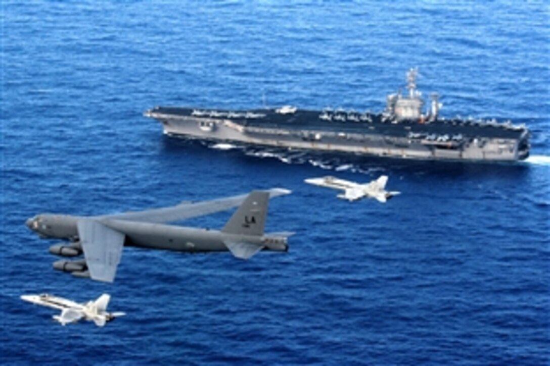 A B-52 Stratofortress flies past the USS Nimitz as two U.S. Navy F/A-18 Hornets intercept during a training excercise. The B-52 is from the 96th Expeditionary Bomb Squadron deployed to Andersen Air Force Base, Guam, May 29, 2008. 