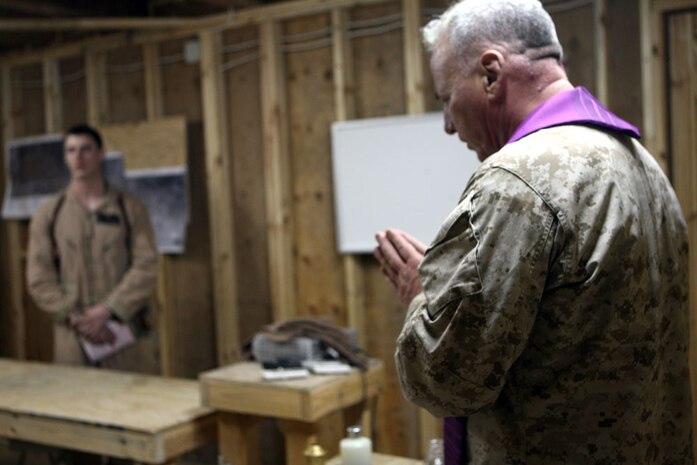 Cmdr. Paul J. Shaughnessy, a Catholic priest with Regimental Combat Team 5, performs a Catholic mass June 5 at Camp Gannon, Iraq. Shaughnessy, who is from Worcester, Mass., is the only catholic priest serving with RCT-5. Father Shaughnessy, which he is often called, routinely travels throughout the regiments' area of operations and speaks with Catholics and service members of various faiths on any issues they may have.