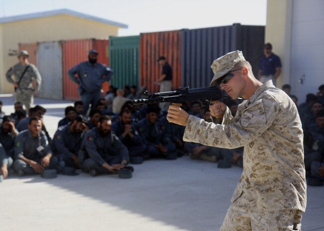 Cpl. Cory J. Becker, Company G, 2nd Battalion, 7th Marine Regiment demonstrates to Afghan National Police Recruits firing positions with the AMD-65 on Lashkar Gah, June 3. 2nd Battalion, 7th Marines, based out of Marine Air Ground Combat Center 29 Palms, is a reinforced light infantry battalion deployed to Afghanistan in support of Operation Enduring Freedom.
