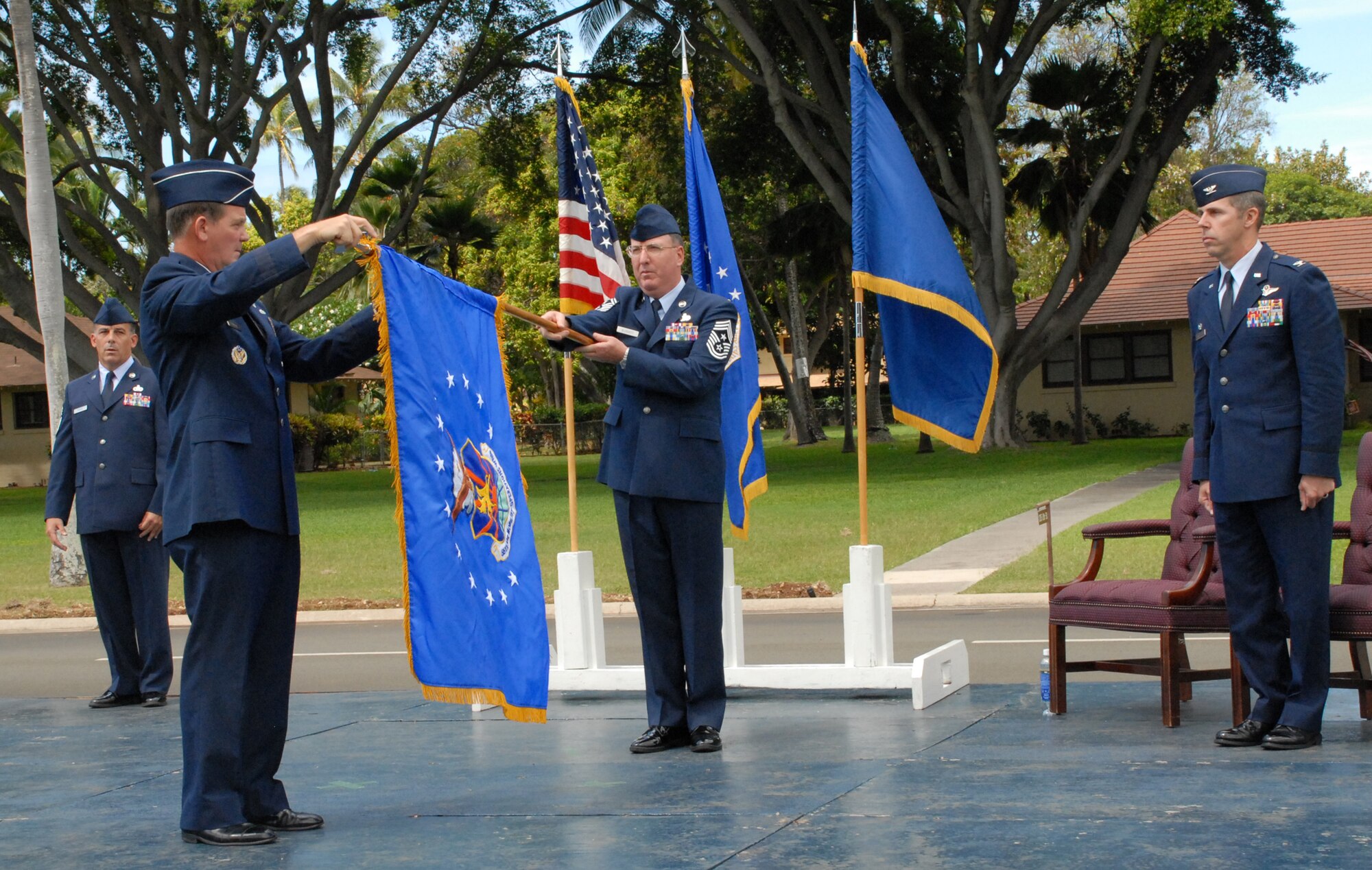 Brig. Gen. Mark Stearns, commander, 15th Expeditionary Mobility Task Force, Travis AFB, Calif., and Chief Master Sgt. Bruce Blodgett, 15th Expeditionary Mobility Task Force command chief, unfurl the 515th Air Mobility Operations Wing Flag, symbolizing the activation of the wing at Hickam AFB. The 515th AMOW is the first wing AMC has established overseas since the command’s formation in 1992. Supporting AMC aircraft and crews transiting the Pacific, the wing becomes the headquarters for the existing 715th Air Mobility Operations Group at Hickam, and the new 515th AMOG at Yokota Air Base, Japan.. (U.S. Air Force Photo/Vanessa Perez)