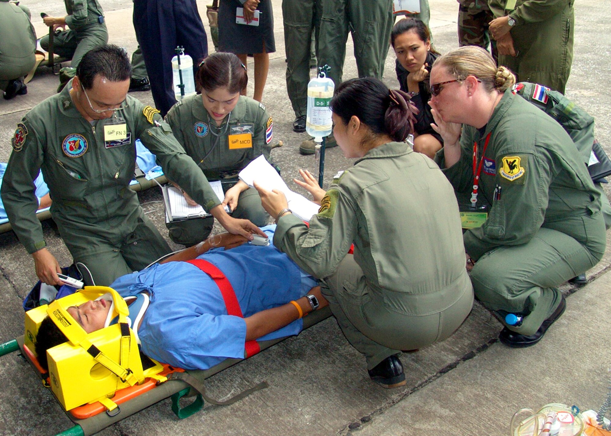 Royal Thai Air Force and the 18th Aeromedical Evacuation Squadron medics stabilize a simulated patient before loading him onto a C-130 Hercules during exercise Pacific Angel 01-08 in Bangkok, Thailand.  Pacific Angel 01-08 is a joint/combined 13th Air Force-led humanitarian assistance operation conducted in the Pacific region. (courtesy photo)
