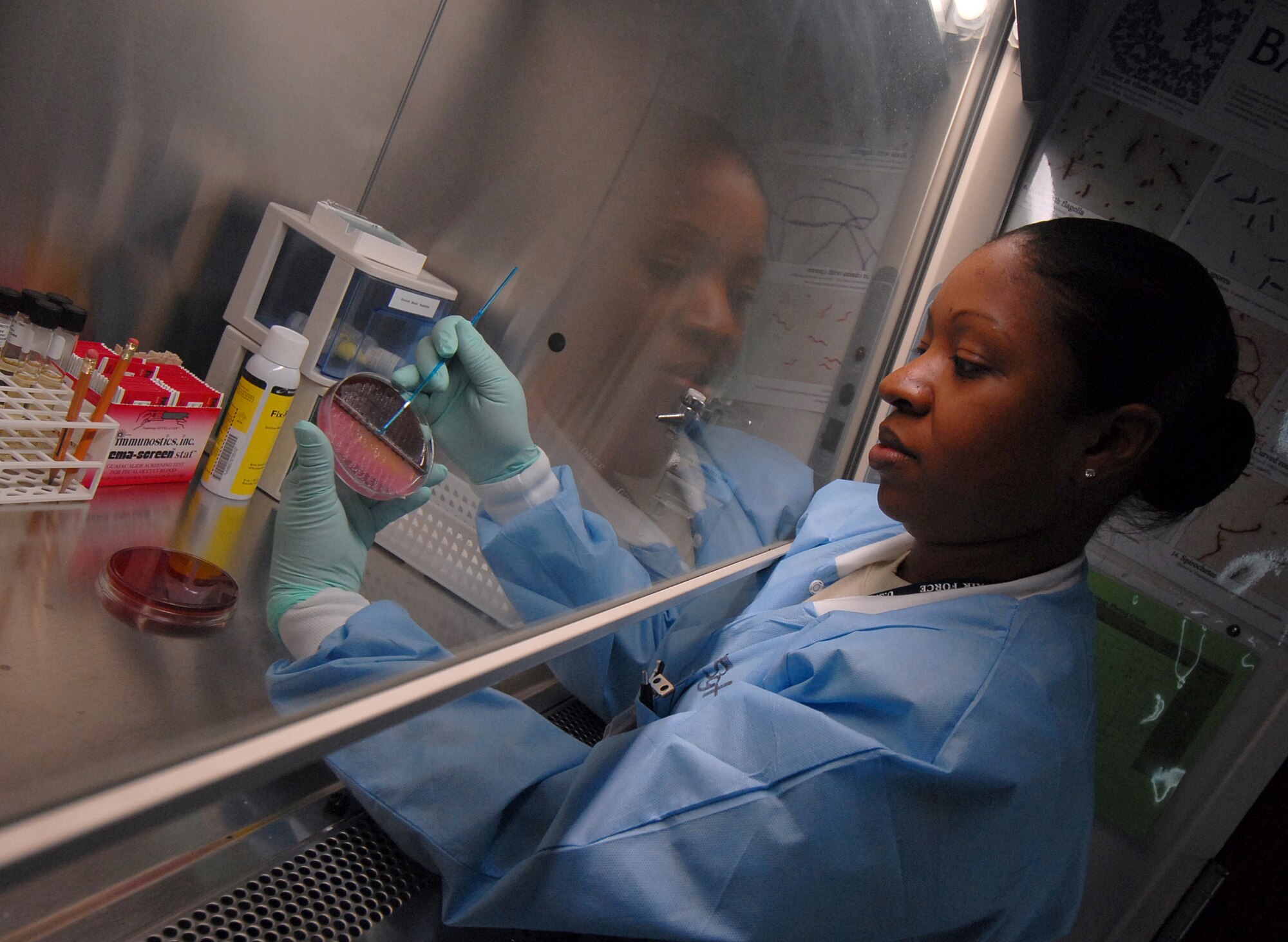 YOKOTA AIR BASE, Japan -- Technical Sergeant Symone Linthicome from the 374th Medical Group, checks a Urine Bi Plate. This inspection helps to see if a patient has bacteria in their urine. (U.S. Air Force photo by Senior Airman Laszlo Babocsi)