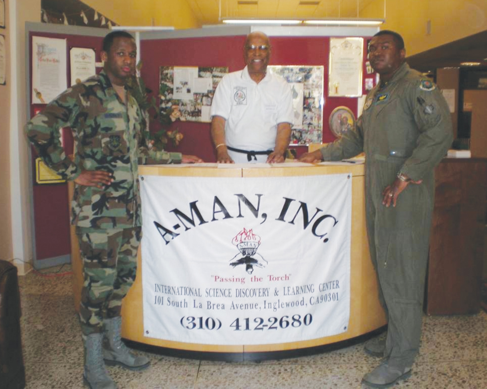 Maj Jermaine Brinson and Lt Rashim McKinney and Hal Walker Jr., co-founder, African-American Male Achievers Network (A-MAN), Inc. stand at the A-MAN booth during the  International Science Discovery and Learning Center in Inglewood, Calif.  (photo by Terita R. Norton, Aerospace Corporation)