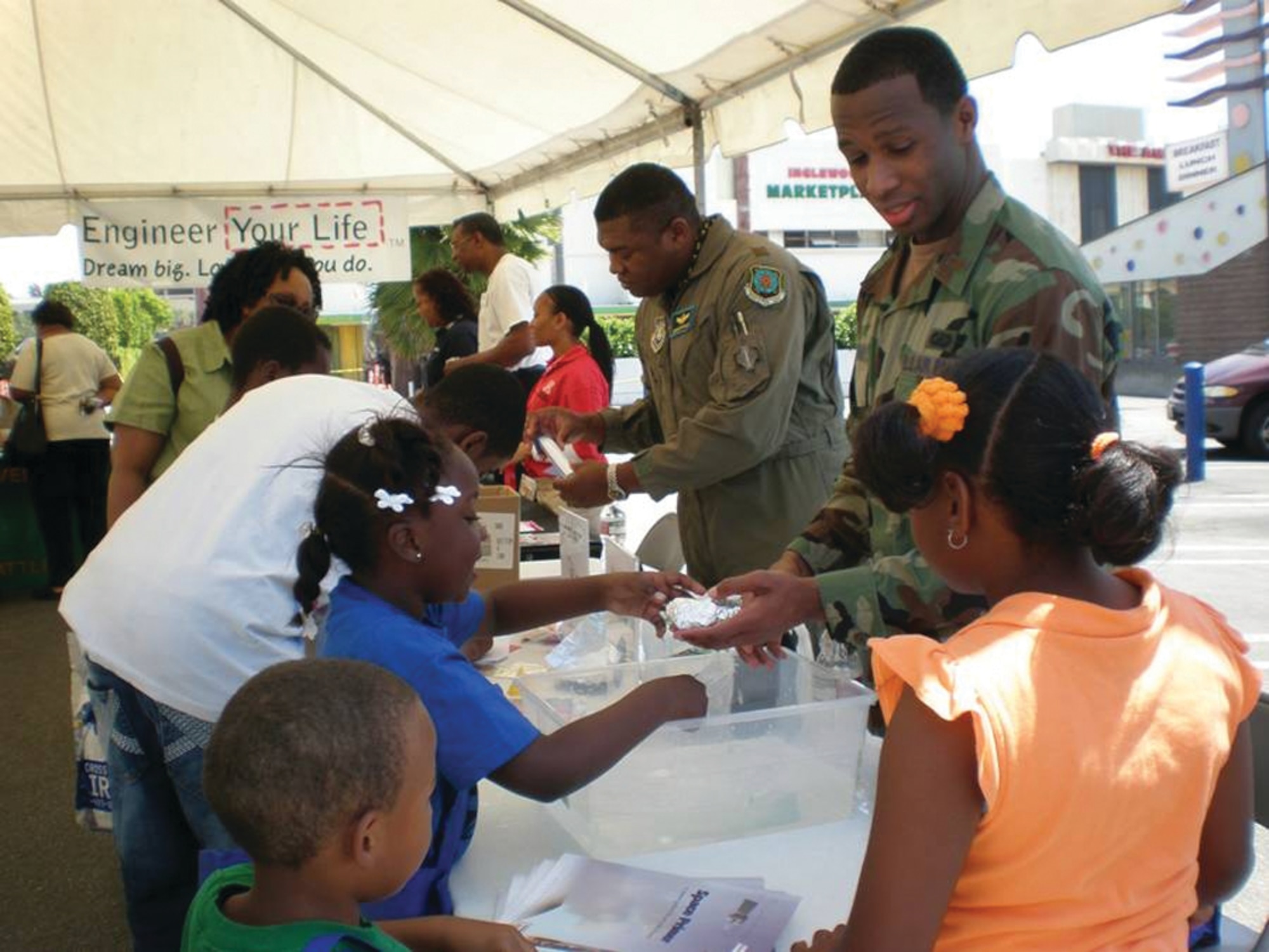 Maj Jermaine Brinson and Lt Rashim McKinney conduct hands-on technology demonstrations at the Day of Industry and Technology event located at the African-American Male Achievers Network (A-MAN), Inc. International Science Discovery and Learning Center in Inglewood, California. (photo by Terita R. Norton, Aerospace Corporation)