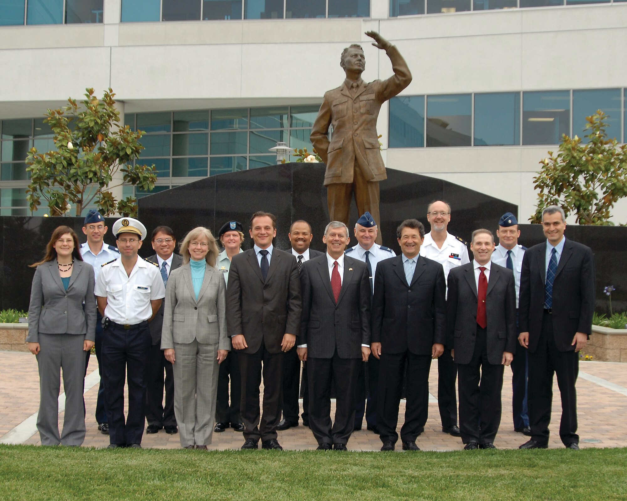 Mr. Francois Lureau, Chief Executive of the Delegation Generale pour lArmement (DGA), Douglas Loverro, Executive Director, Space and Missile Systems Center, Richard McKinney, Director, European Space Liaison, Office of the Under Secretary of the Air Force and Delegation Members stand in front of the Schriever memorial for a group photo, June 4 (photo by Joe Juarez)