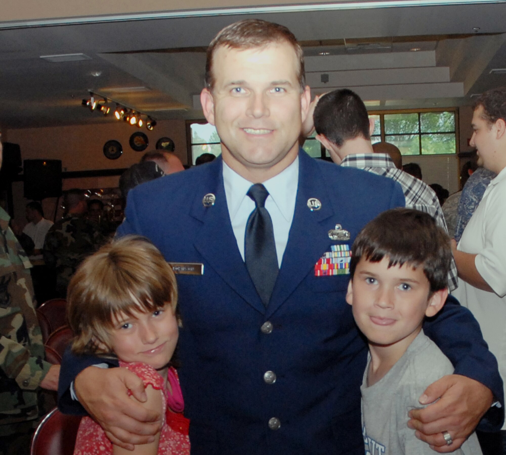 Air Force Reserve Master Sgt. Lloyd Robinson gets a hug from his children after his induction into the 940th Air Refueling Wing Top Three Group May 4, 2008. An information management specialist for the 940th Maintenance Squadron, he was one of thirteen new Air Force Reserve master sergeants inducted into the group in a ceremony at the Recce Point Club, Beale Air Force Base, Calif. (U.S. Air Force photo/Tech. Sgt. Brandie Brockett)


