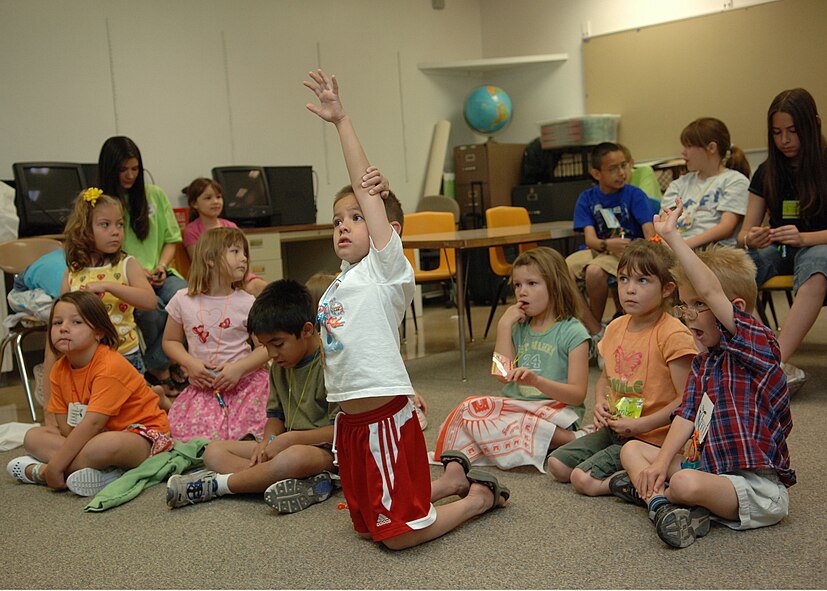 Children raise there hands in eagerness to answer the question 'what are different types of sins?' during vacation bible school, June 5.  (U.S. Air Force photo/Airman 1st Class John Strong) 
 