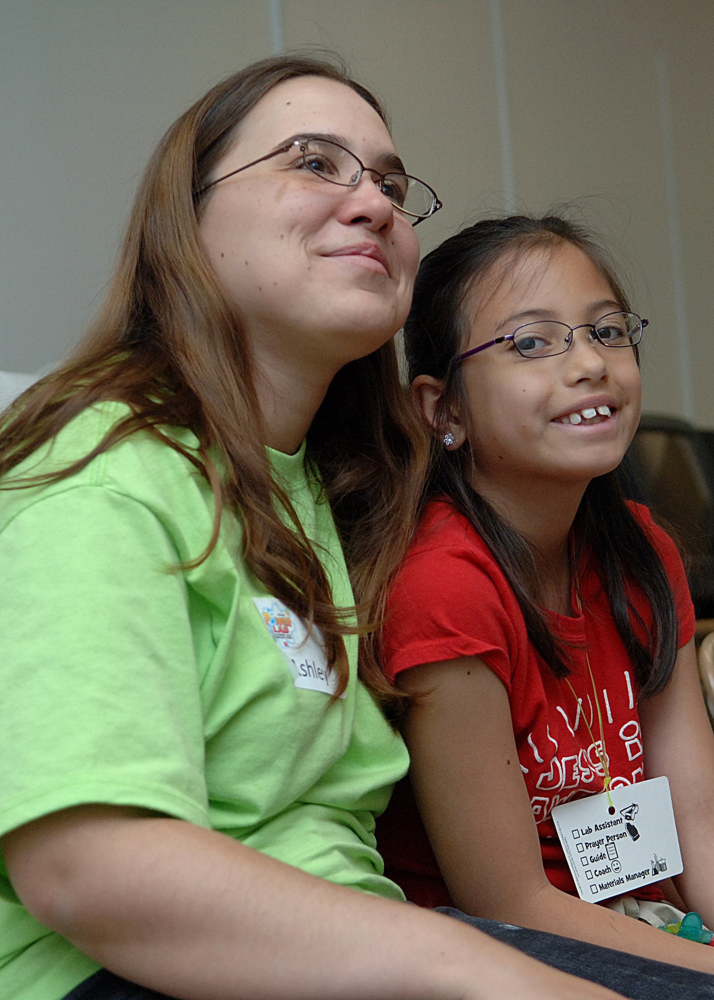Airman 1st Class Ashley Moore of the 49th Operations Group listens with a child to the lesson of the day at vacation bible school on Holloman Air Force Base, N.M., June 5.  (U.S. Air Force photo/Airman 1st Class John Strong) 
  
