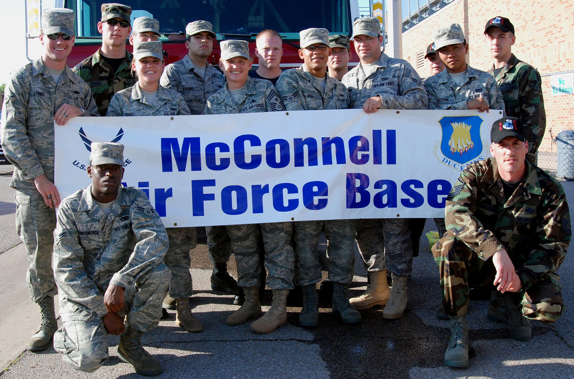 MCCONNELL AIR FORCE BASE, Kan. -- McConnell’s First Term Airman’s Center graduates, Chief Master Sergeant Peggy Savage, 22nd Air Refueling Wing command chief, and members of the McConnell Fire Department display McConnell’s Air Power pride in the Derby Days Parade, May 30, Derby, Kan. (Photo by Airman 1st Class Jessica Lockoski)